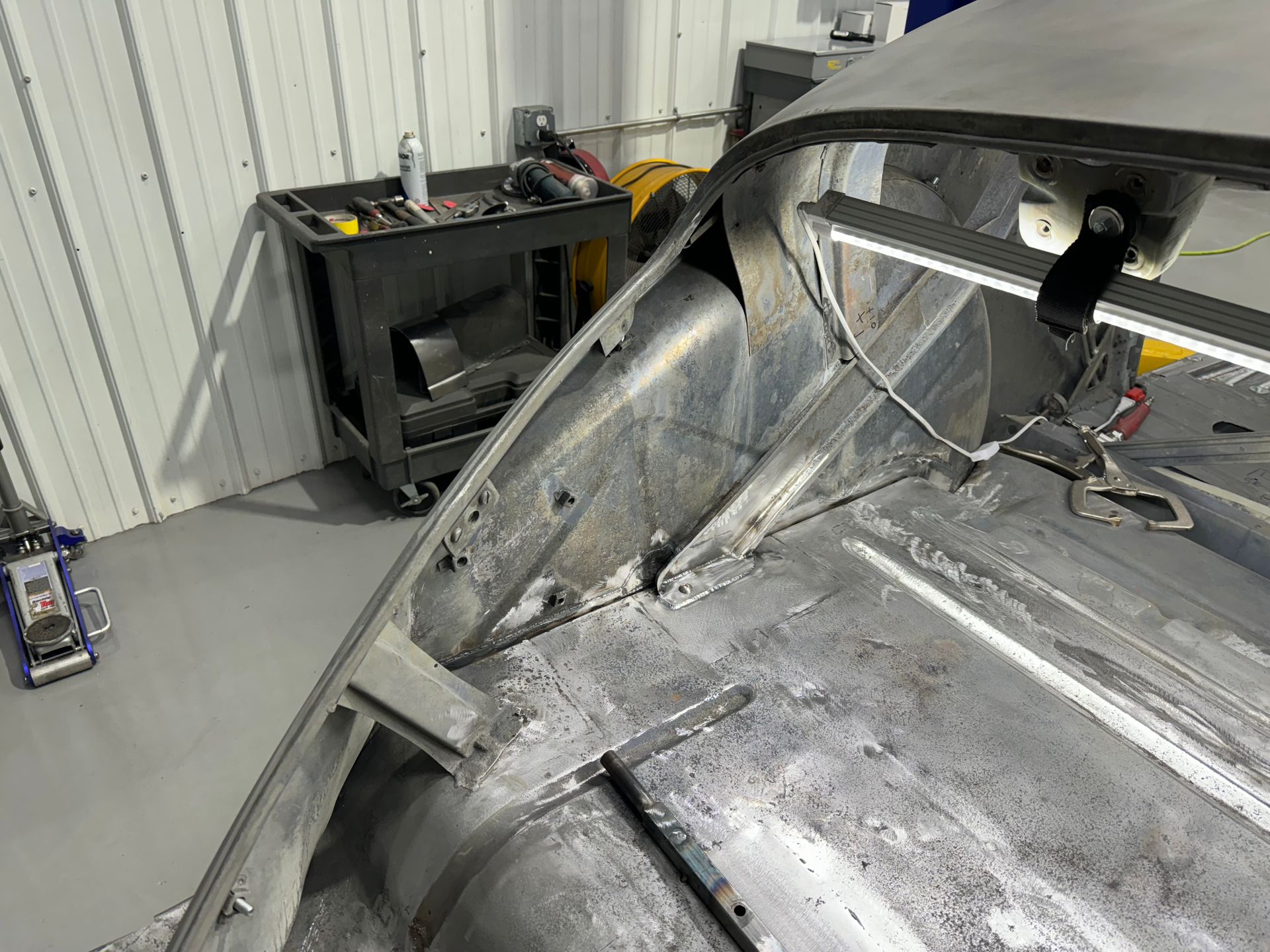 A car is being worked on in a garage.