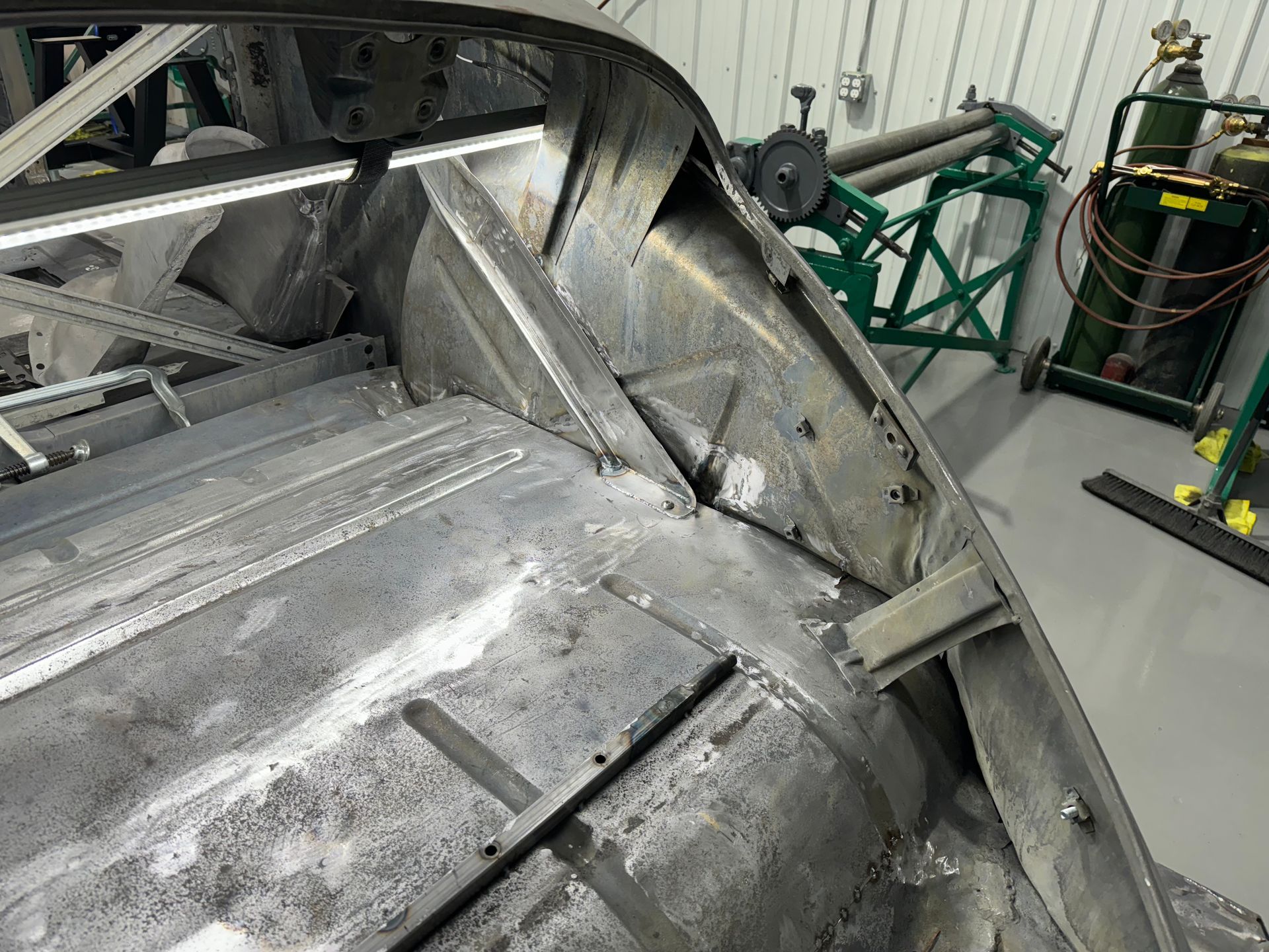 A large piece of metal is sitting in a garage.