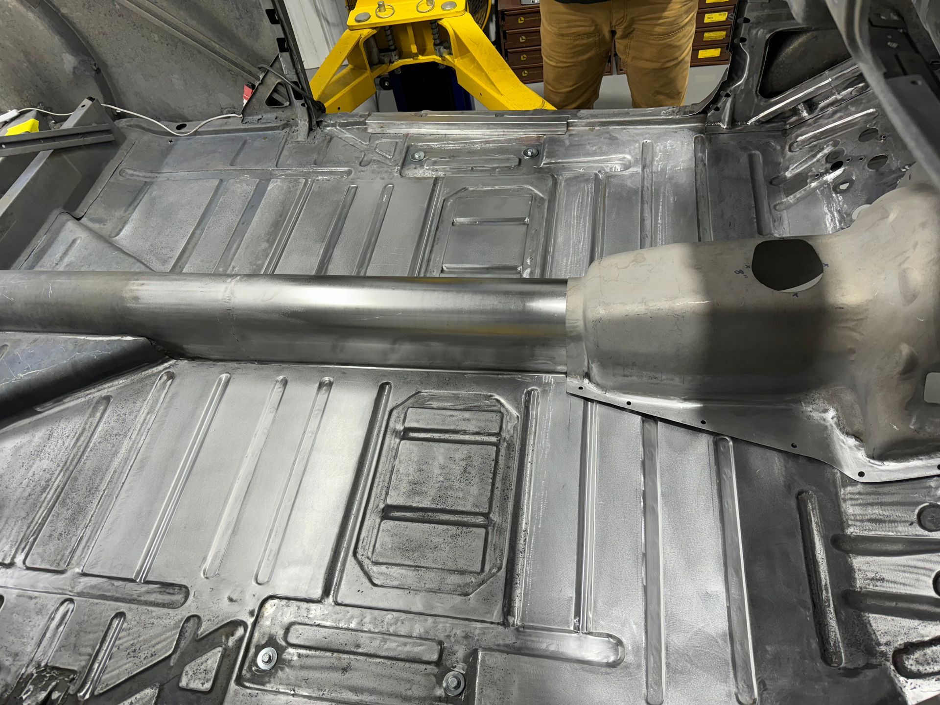 A man is standing in the back of a car.