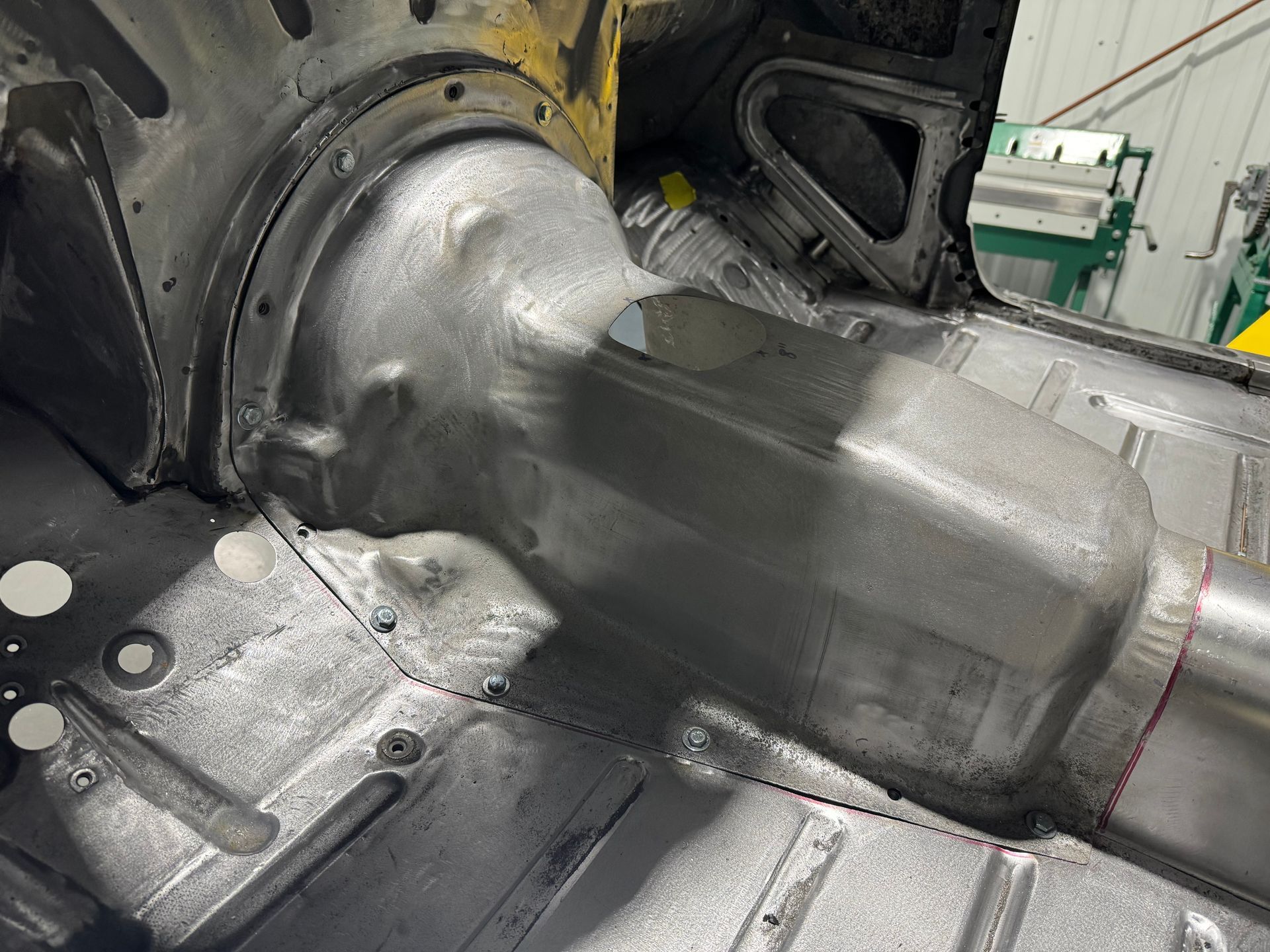 A close up of a metal object in a garage.