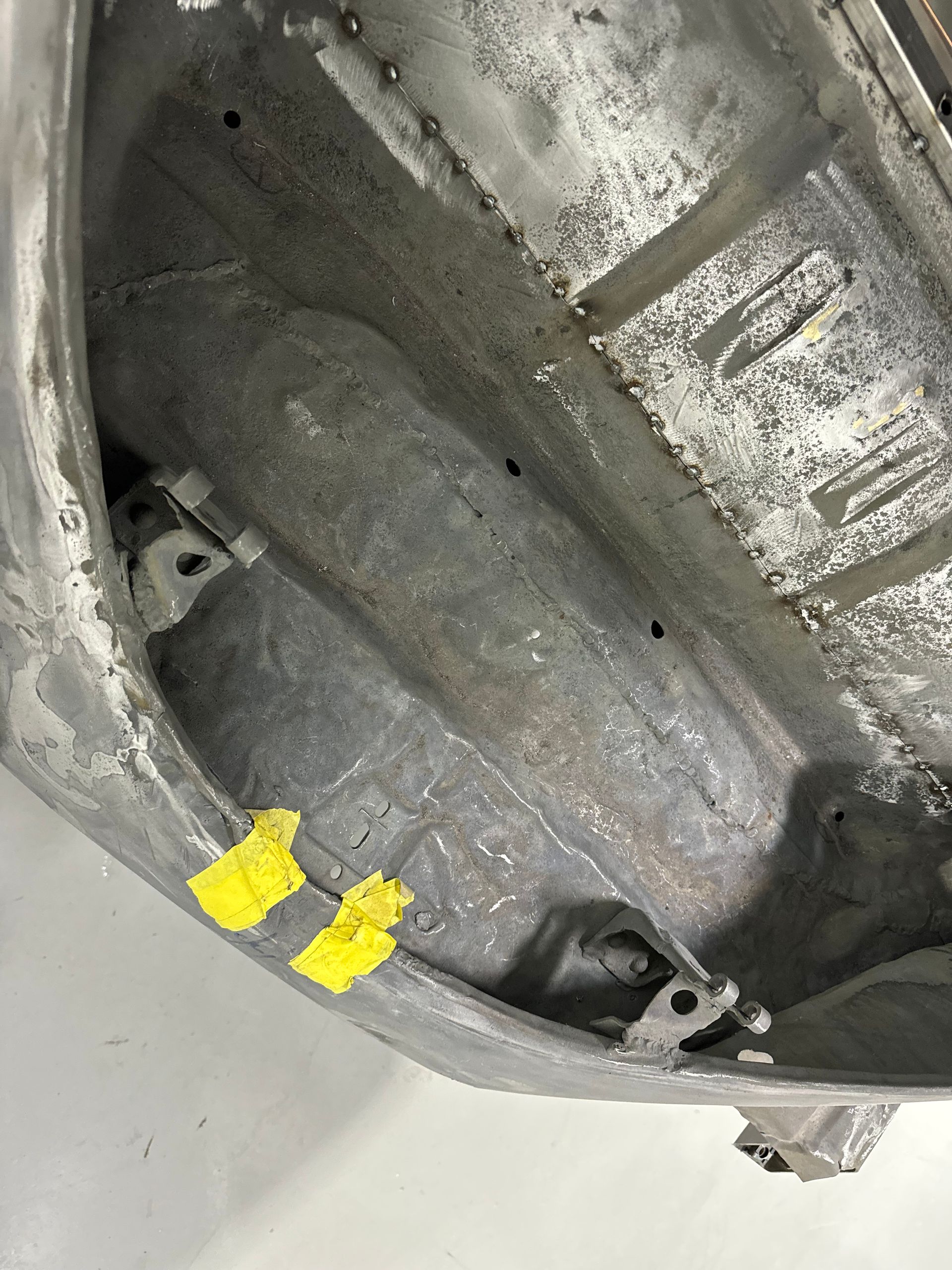 A close up of a metal object with yellow stickers on it.