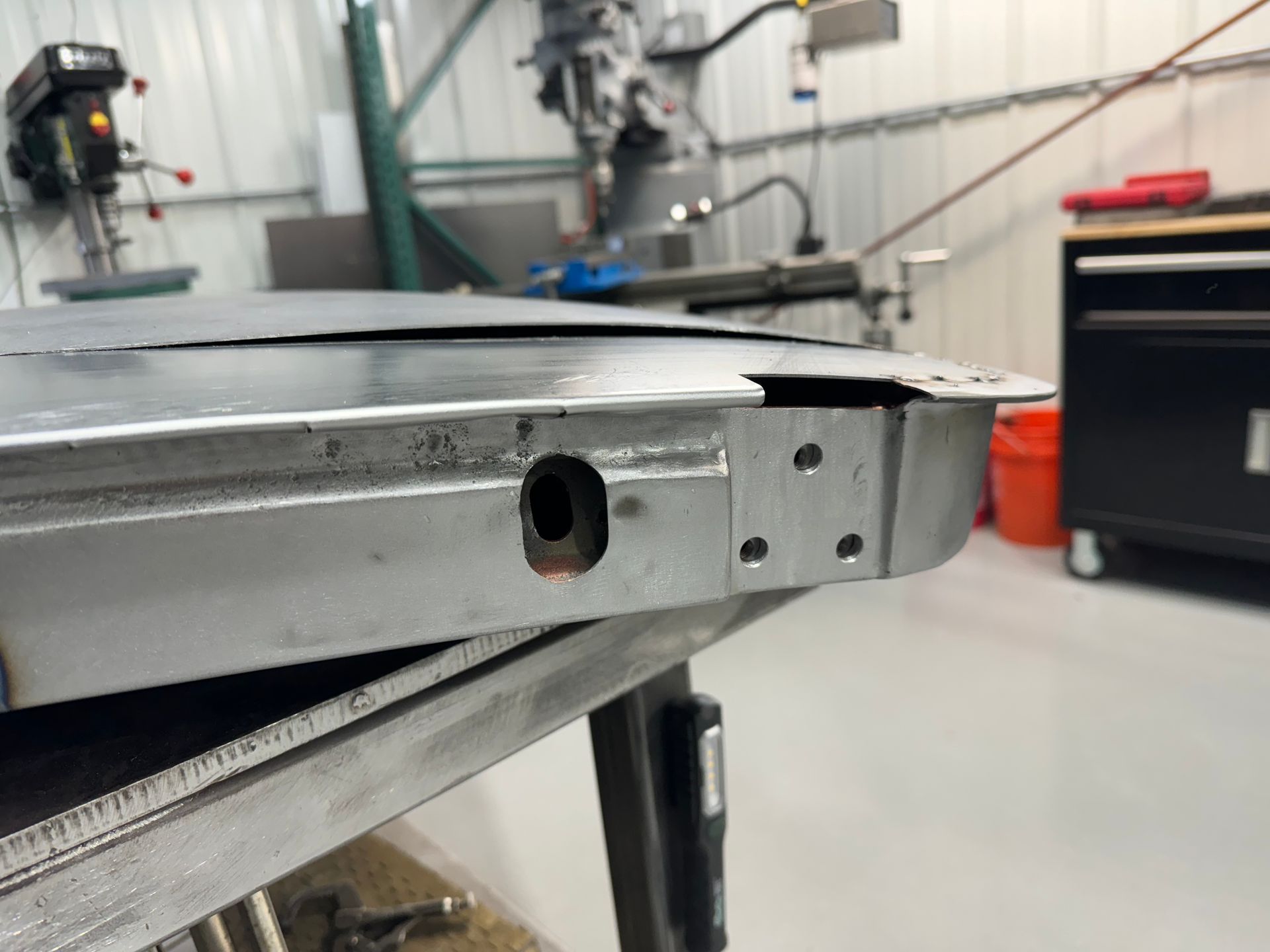 A piece of metal is sitting on top of a table in a workshop.