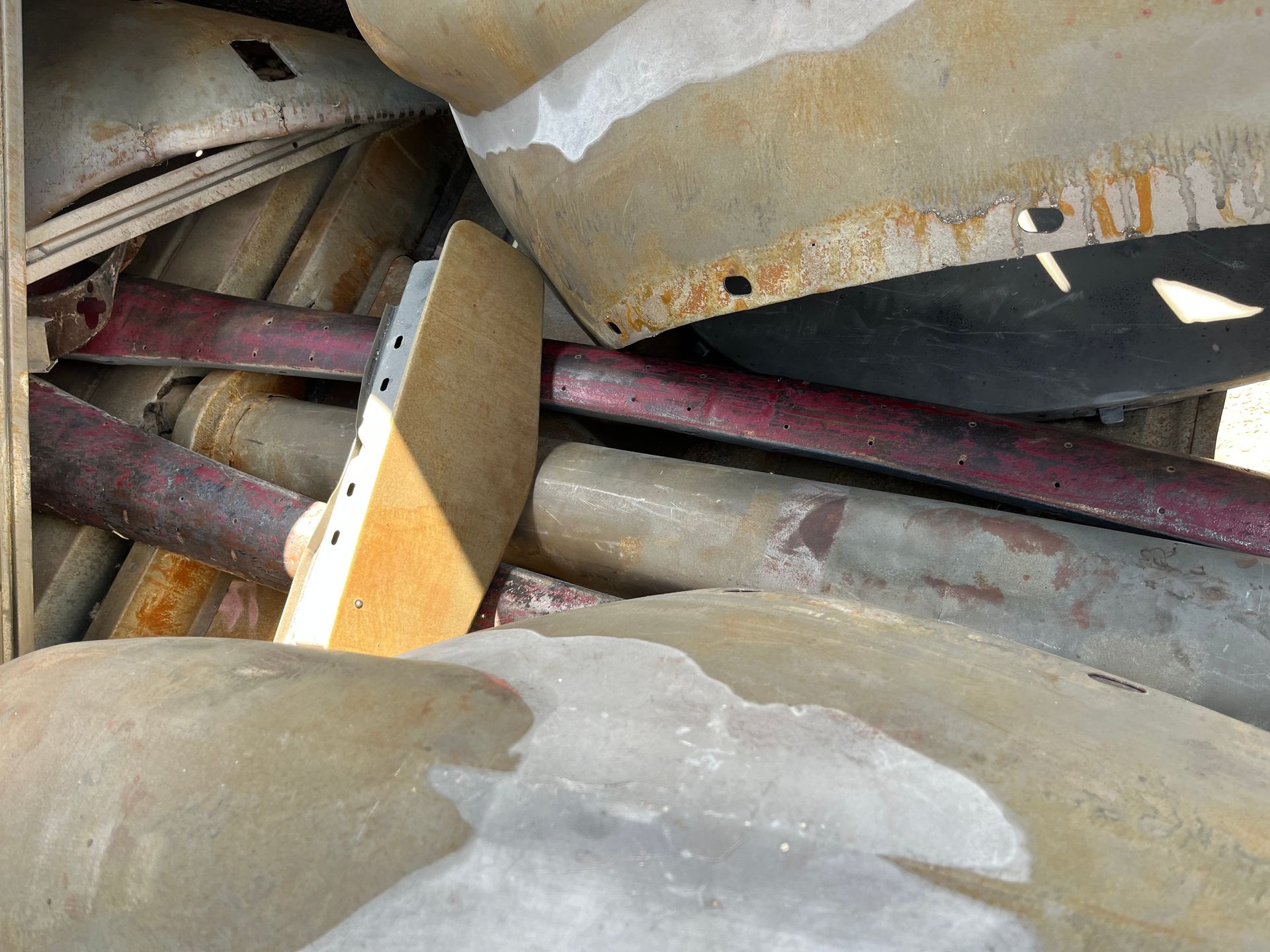 A pile of rusty metal pieces are stacked on top of each other.