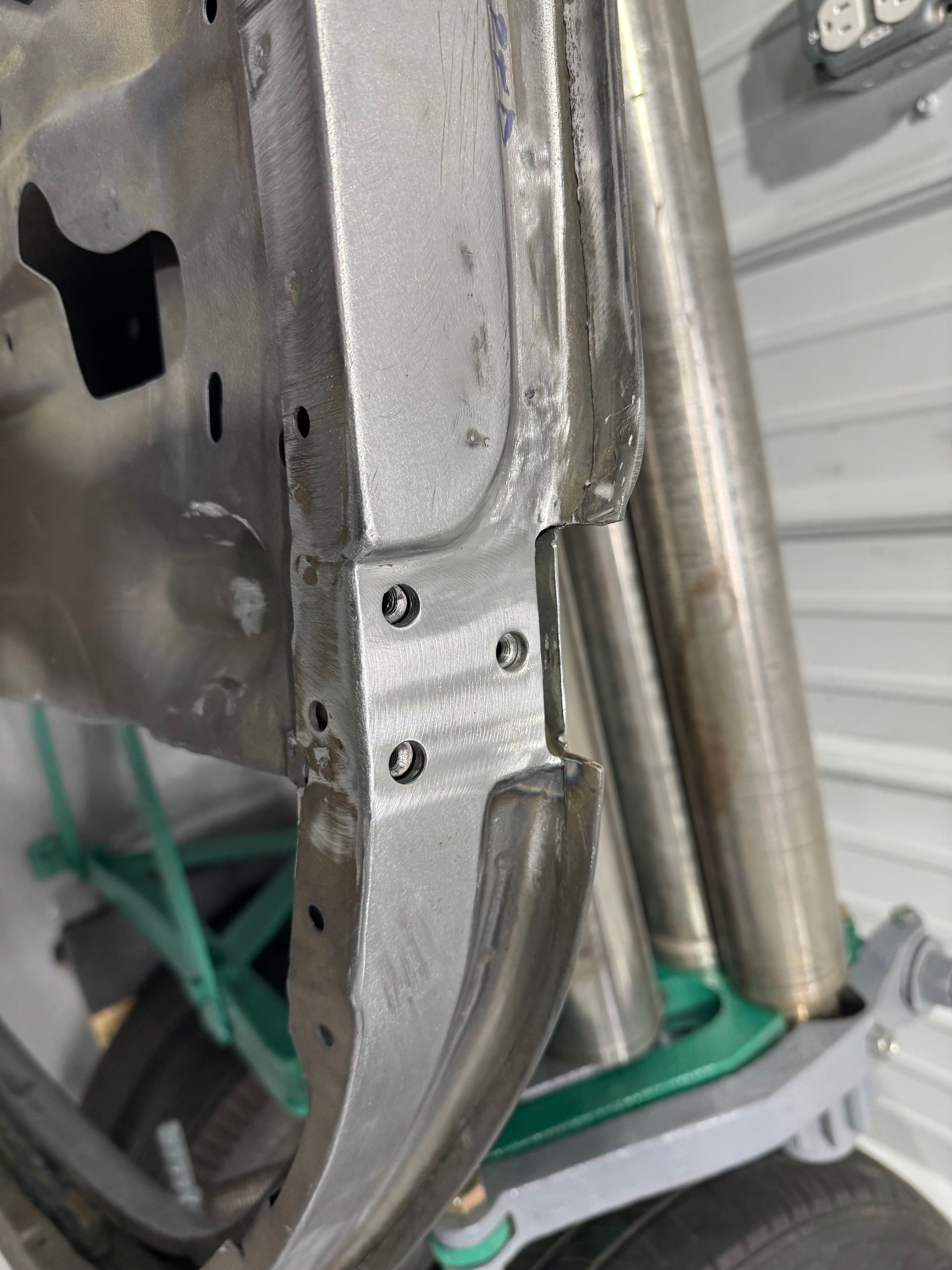 A close up of a metal frame on a motorcycle.