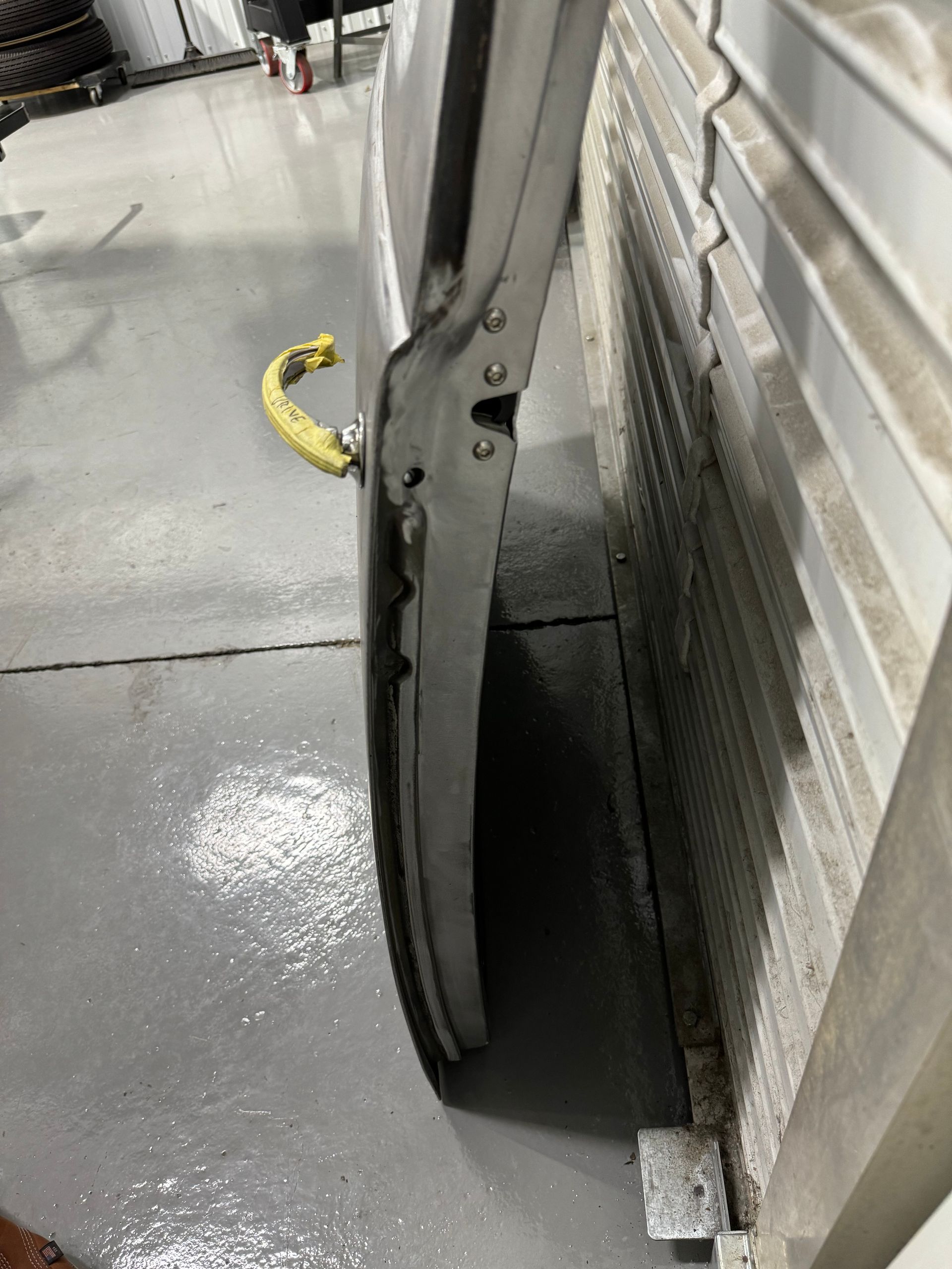 A close up of a door with a yellow chain attached to it.