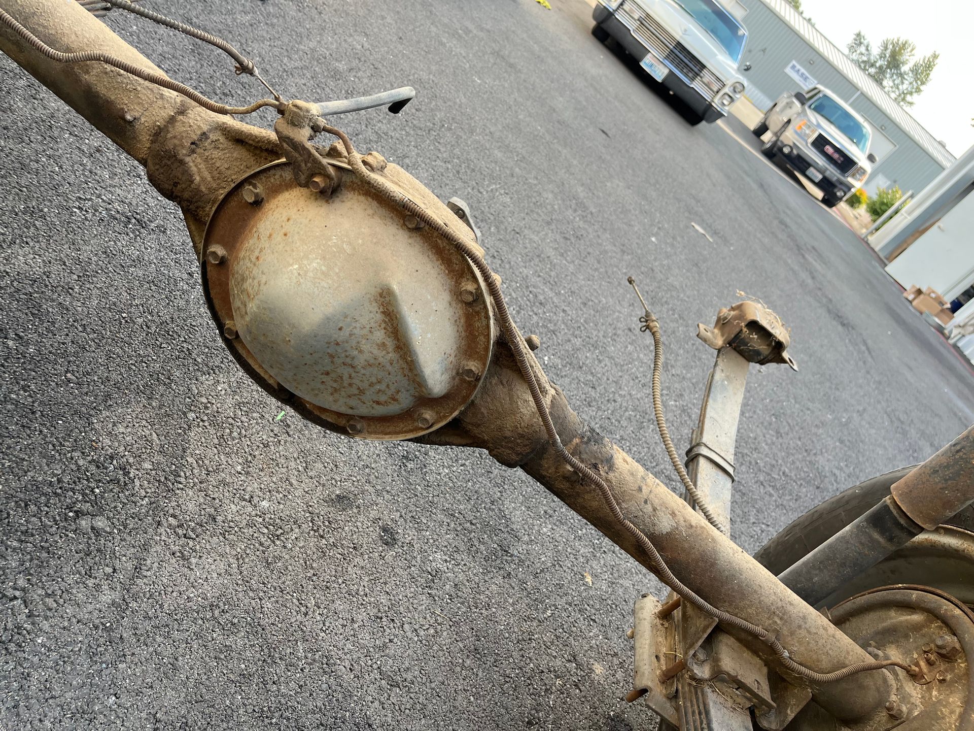 A close up of a rear axle on a road
