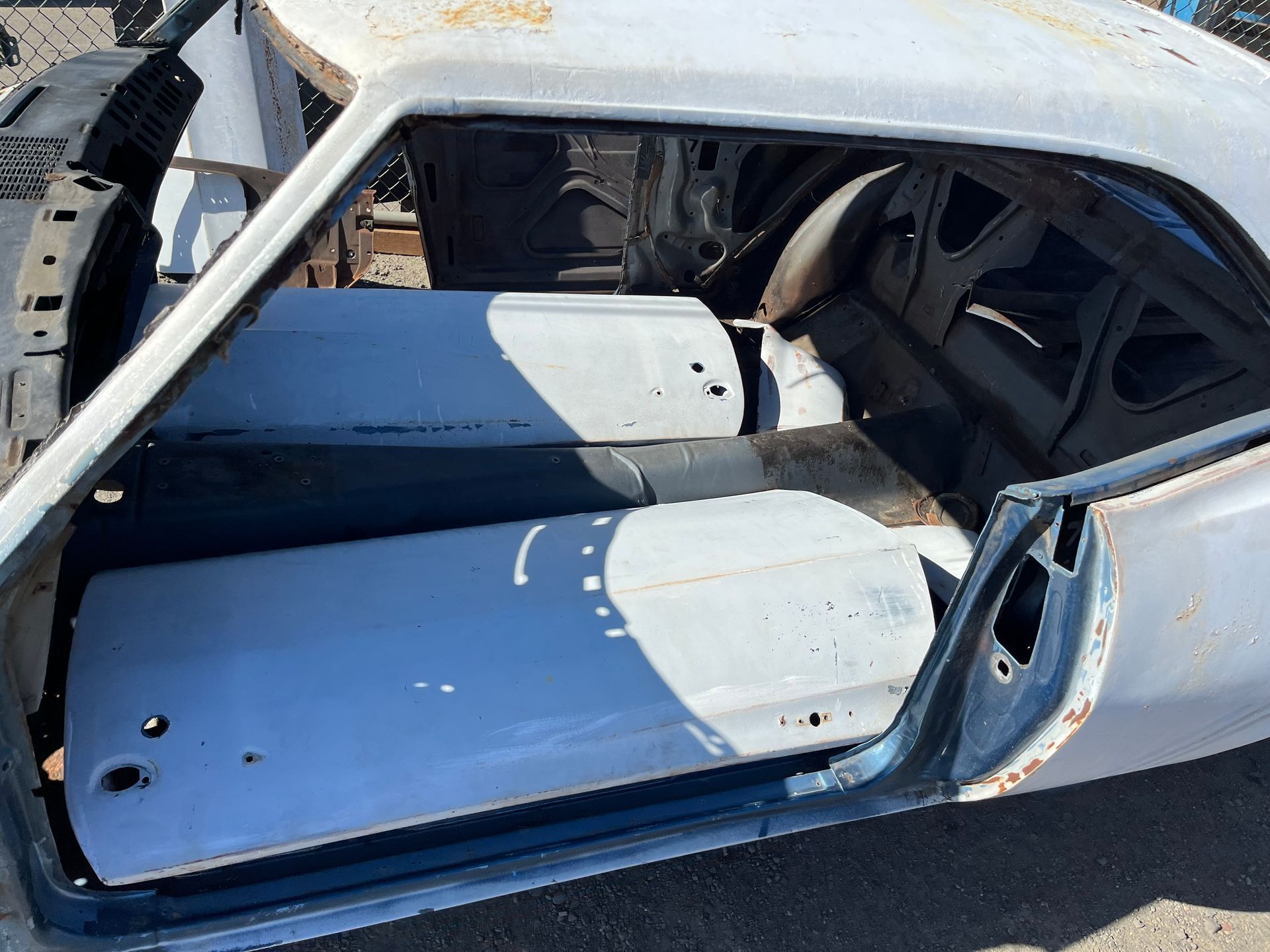 The inside of an old car with the door open