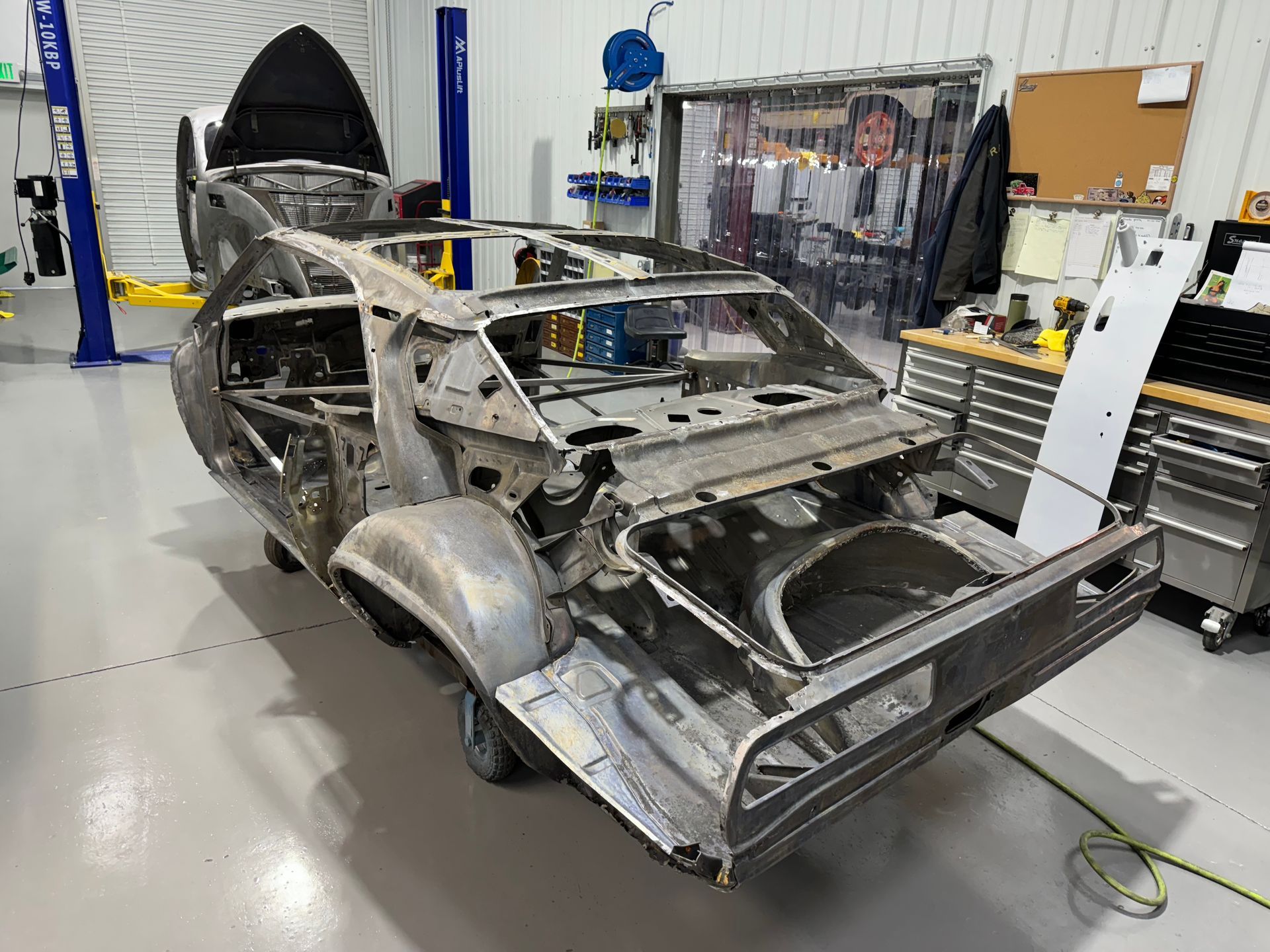 A car is being built in a garage.