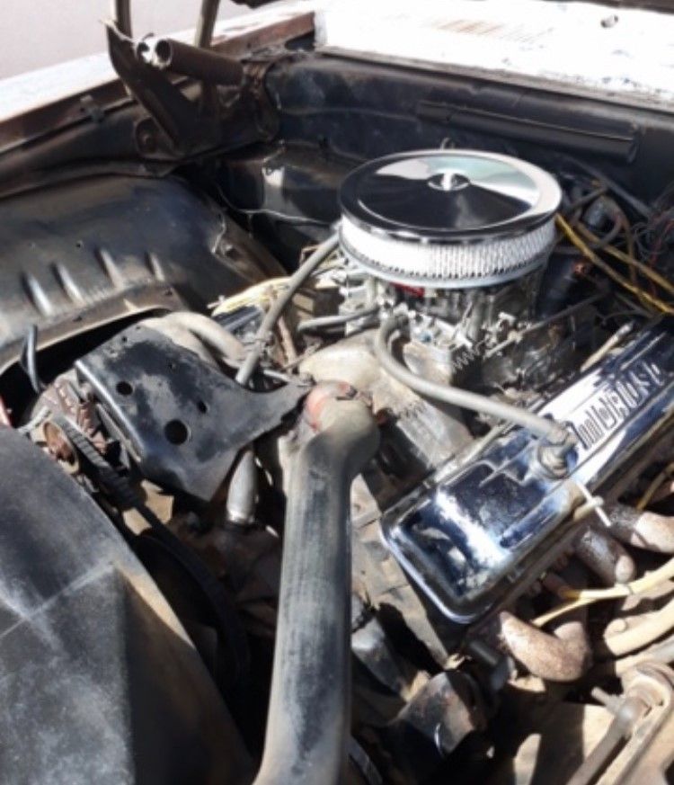 A close up of a car engine with the word chevrolet on it