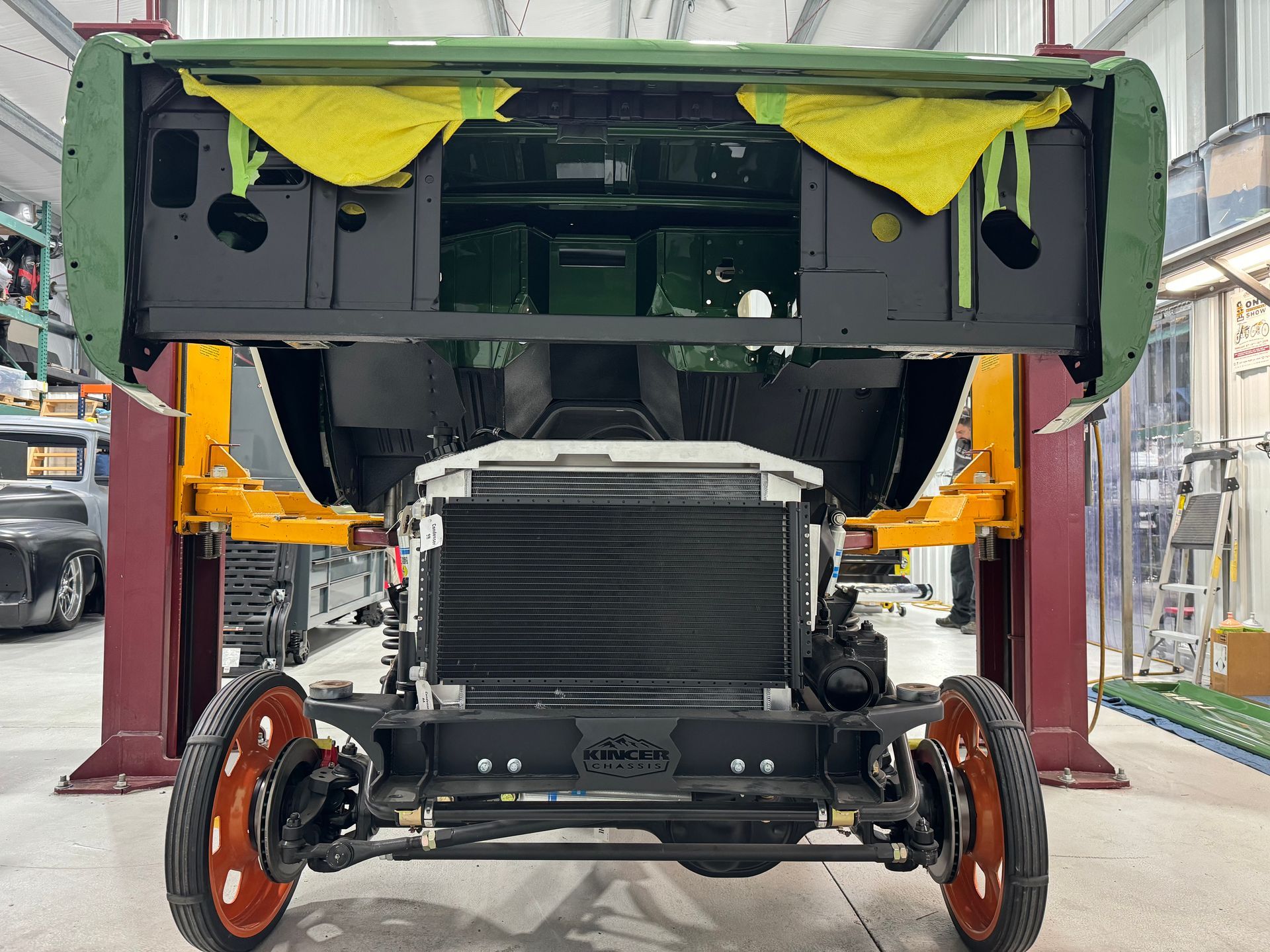 A car is being built on a lift in a garage.