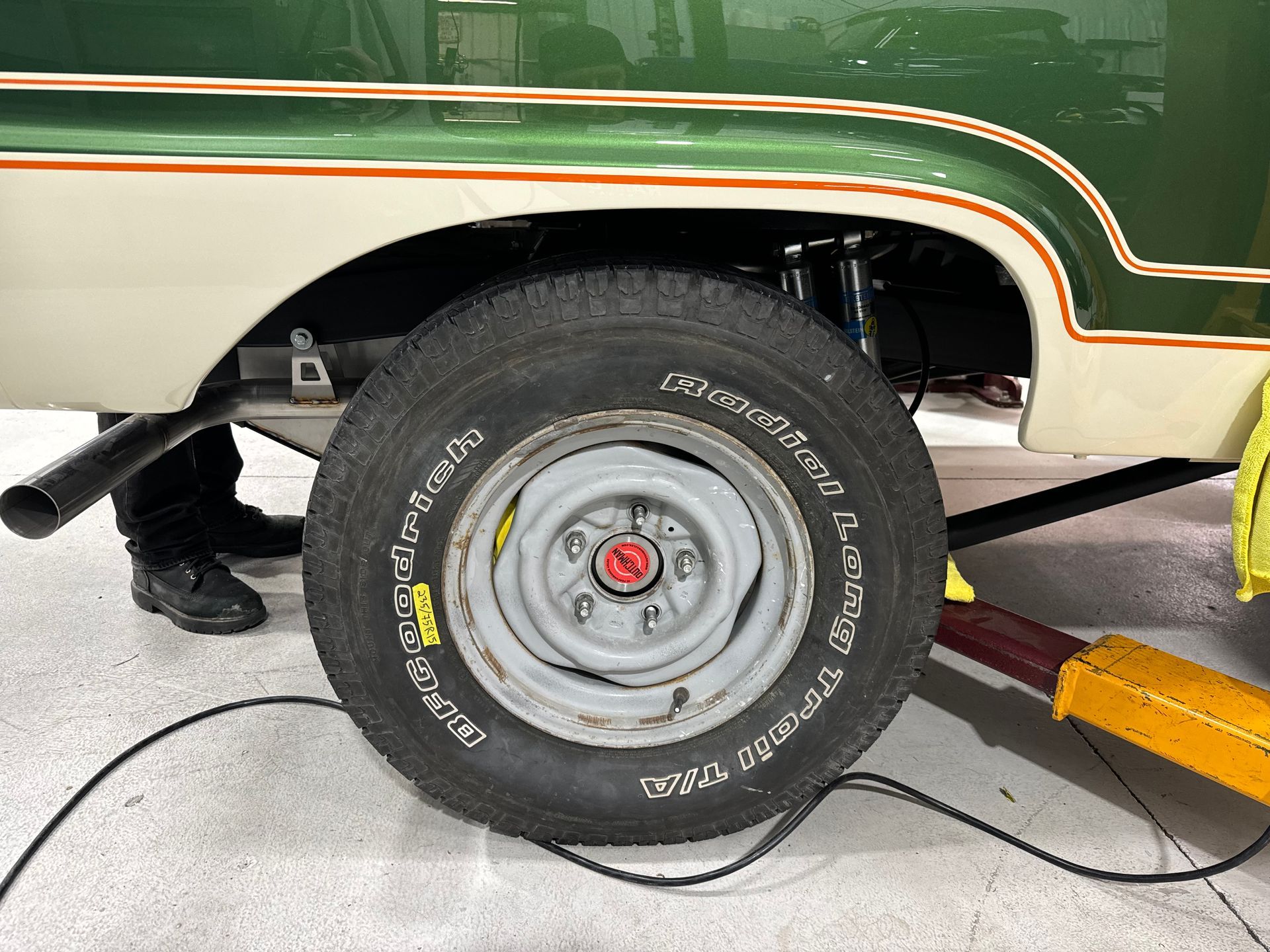 A green truck with a bfgoodrich tire on it