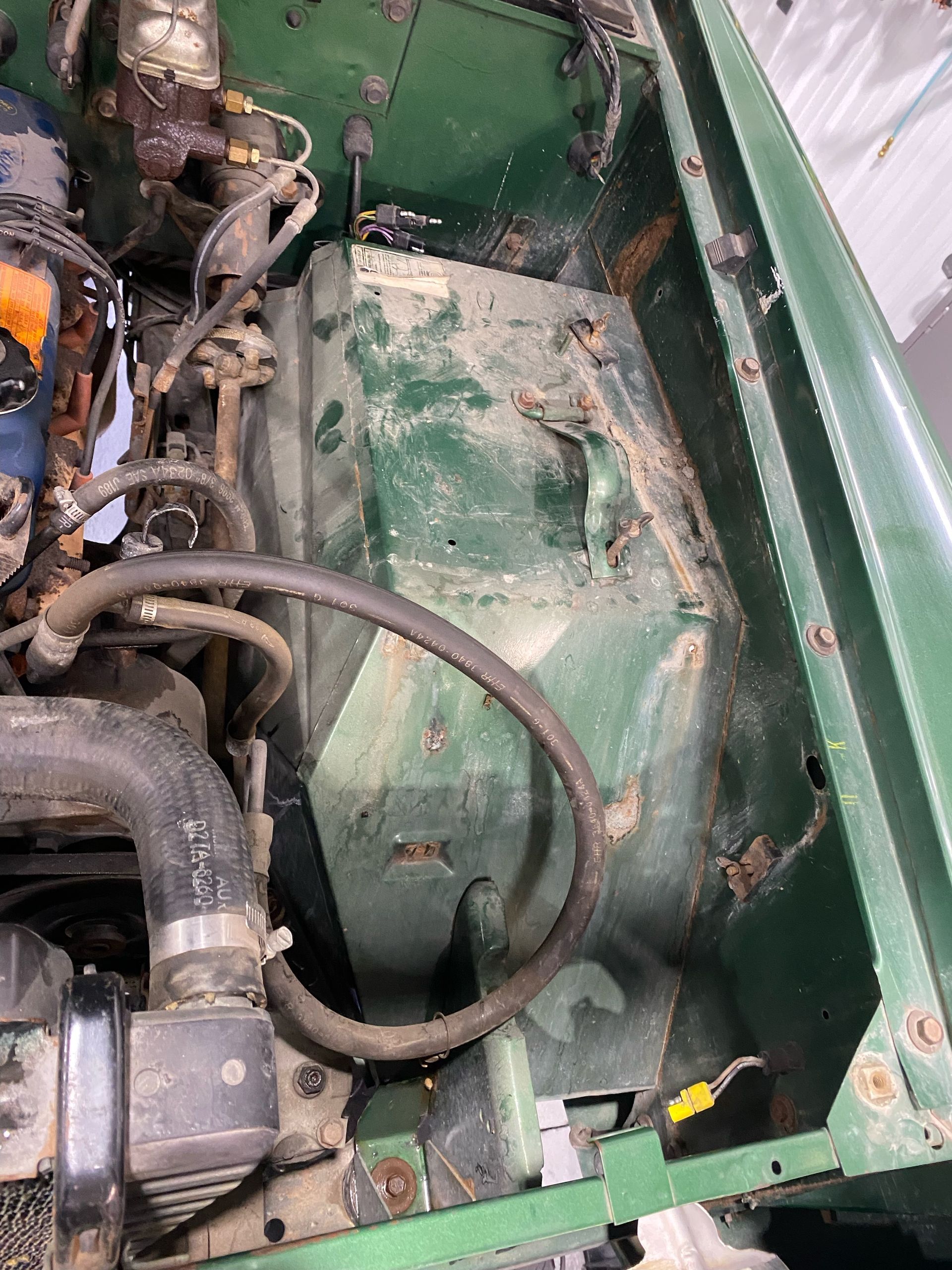 A close up of the engine of a green vehicle.