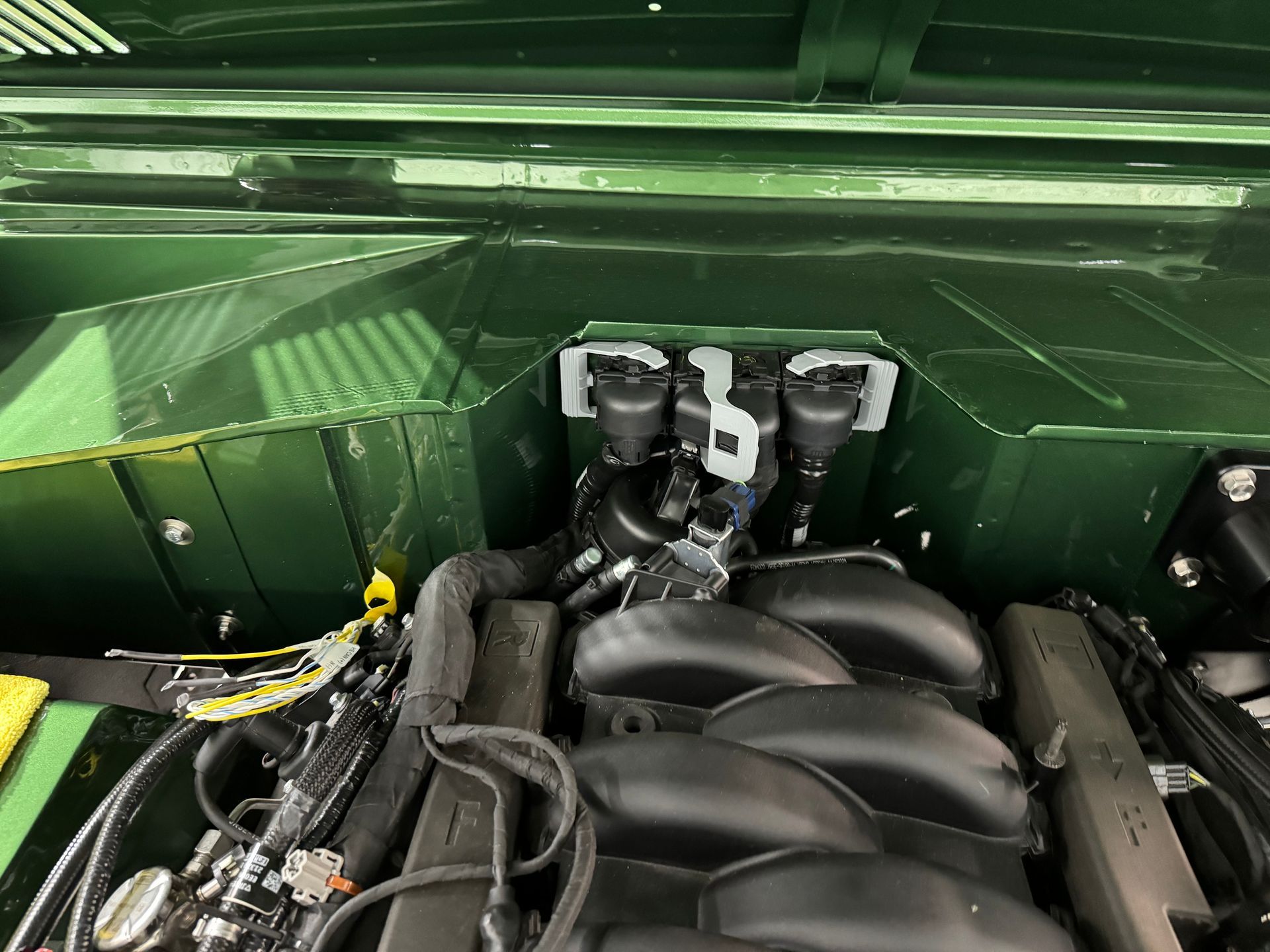 A close up of the engine of a green car