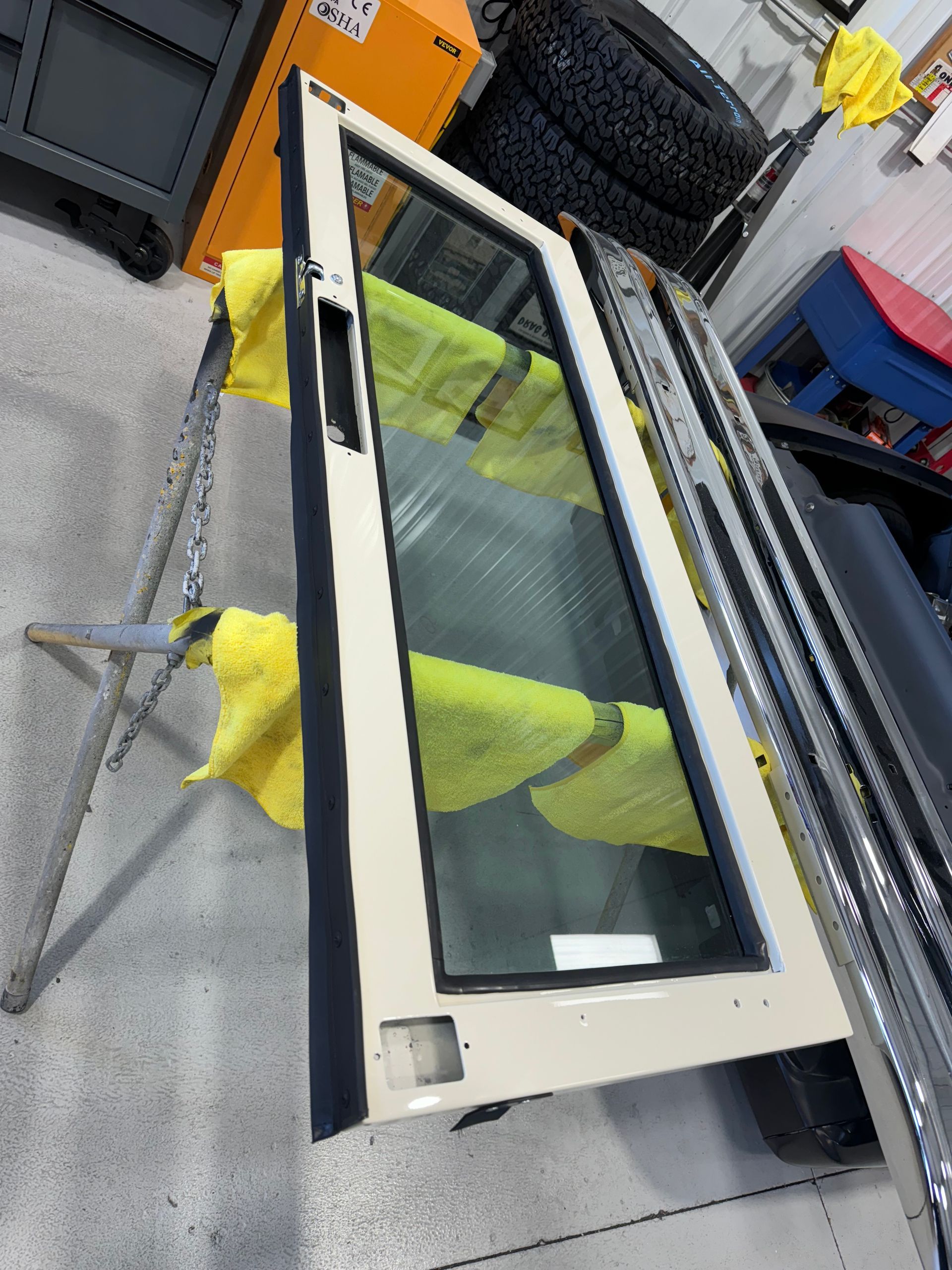 A door is sitting on a metal stand in a garage