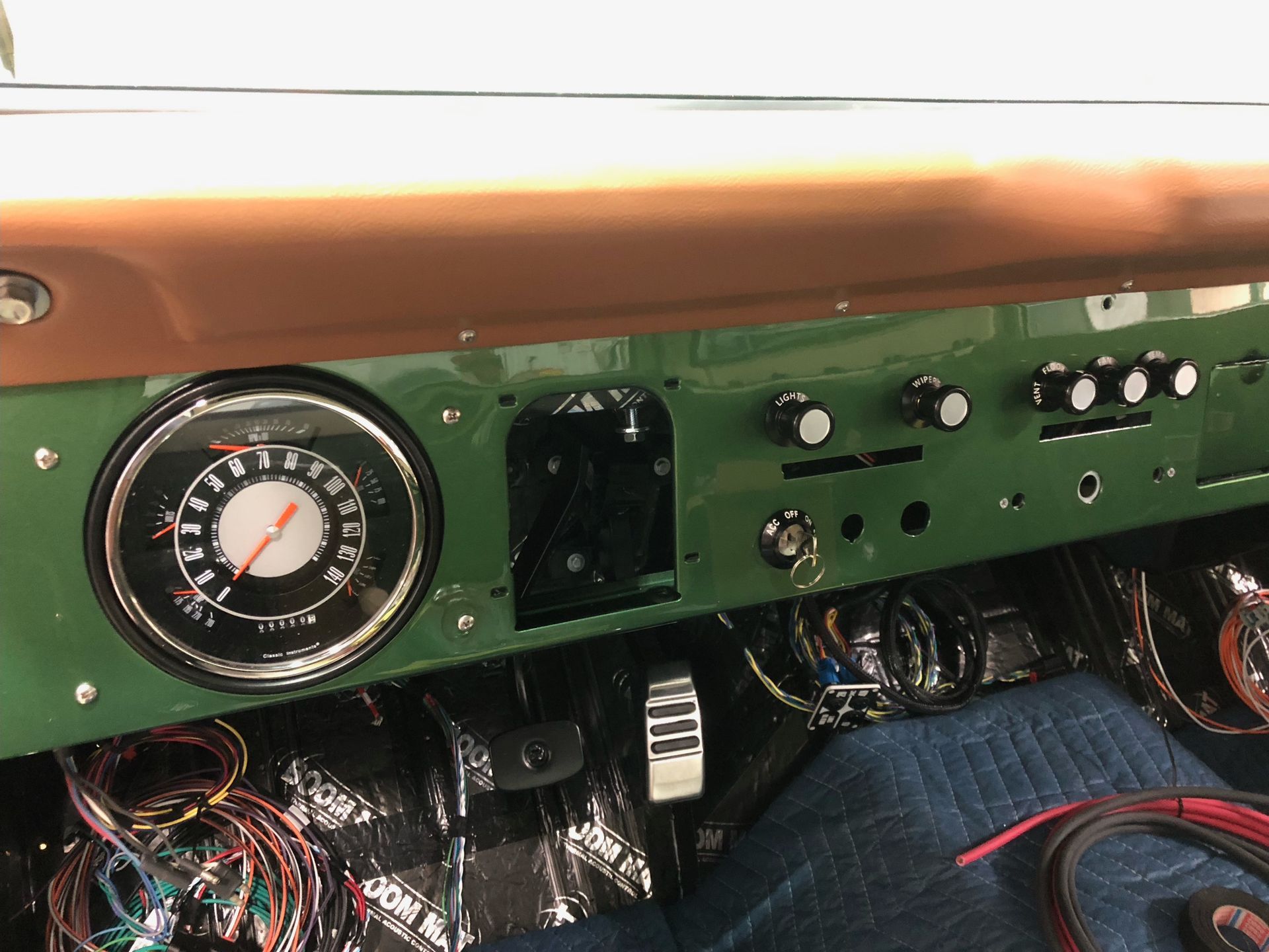 A green dashboard with a speedometer and buttons on it