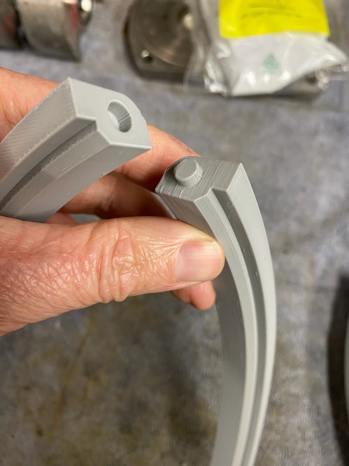 A person is holding a piece of plastic in their hand.