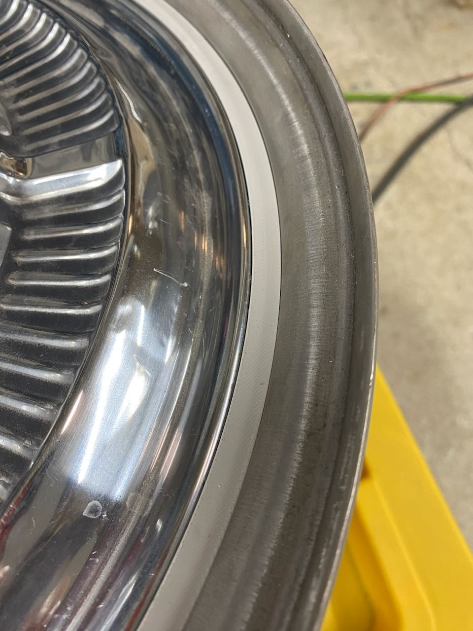 A close up of a wheel on a yellow box.