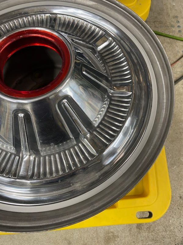 A close up of a wheel on a yellow container