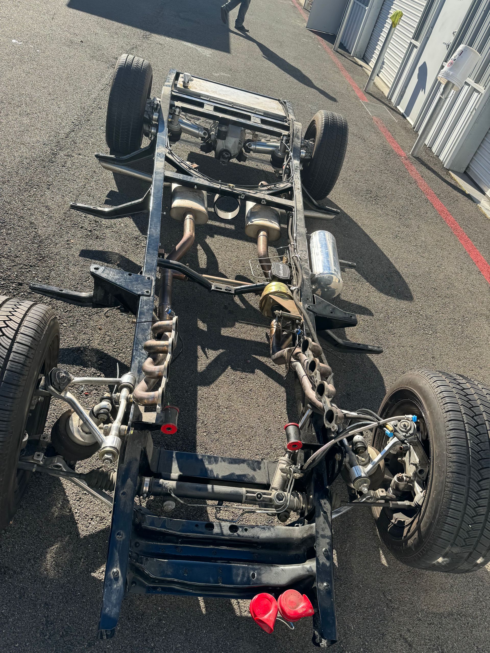 The chassis of a truck is laying on the ground.