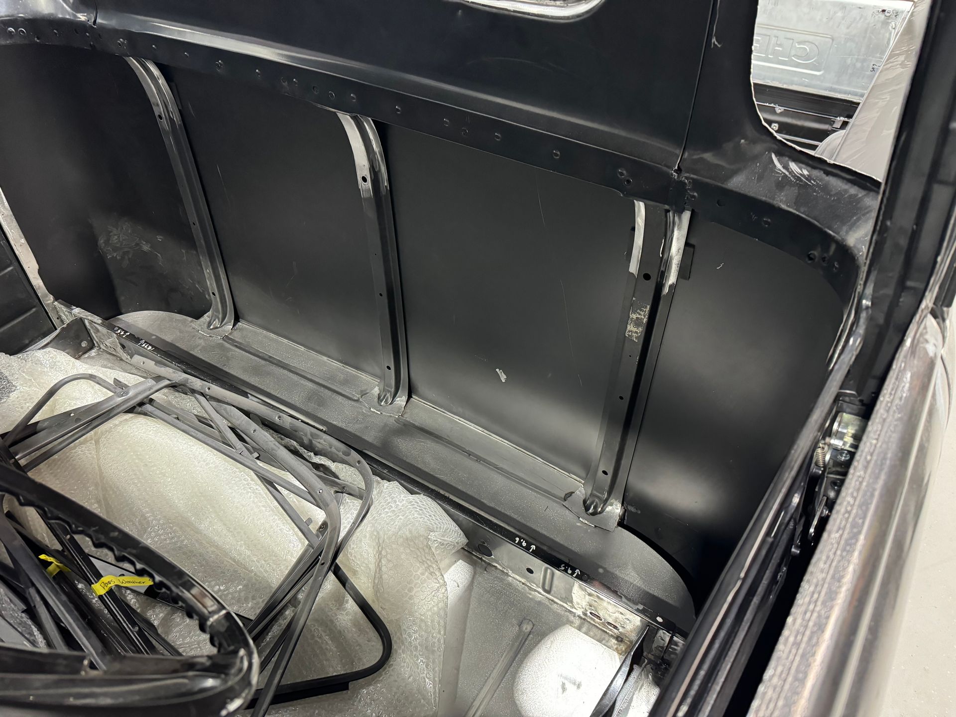 The trunk of a car with a lot of wires coming out of it.