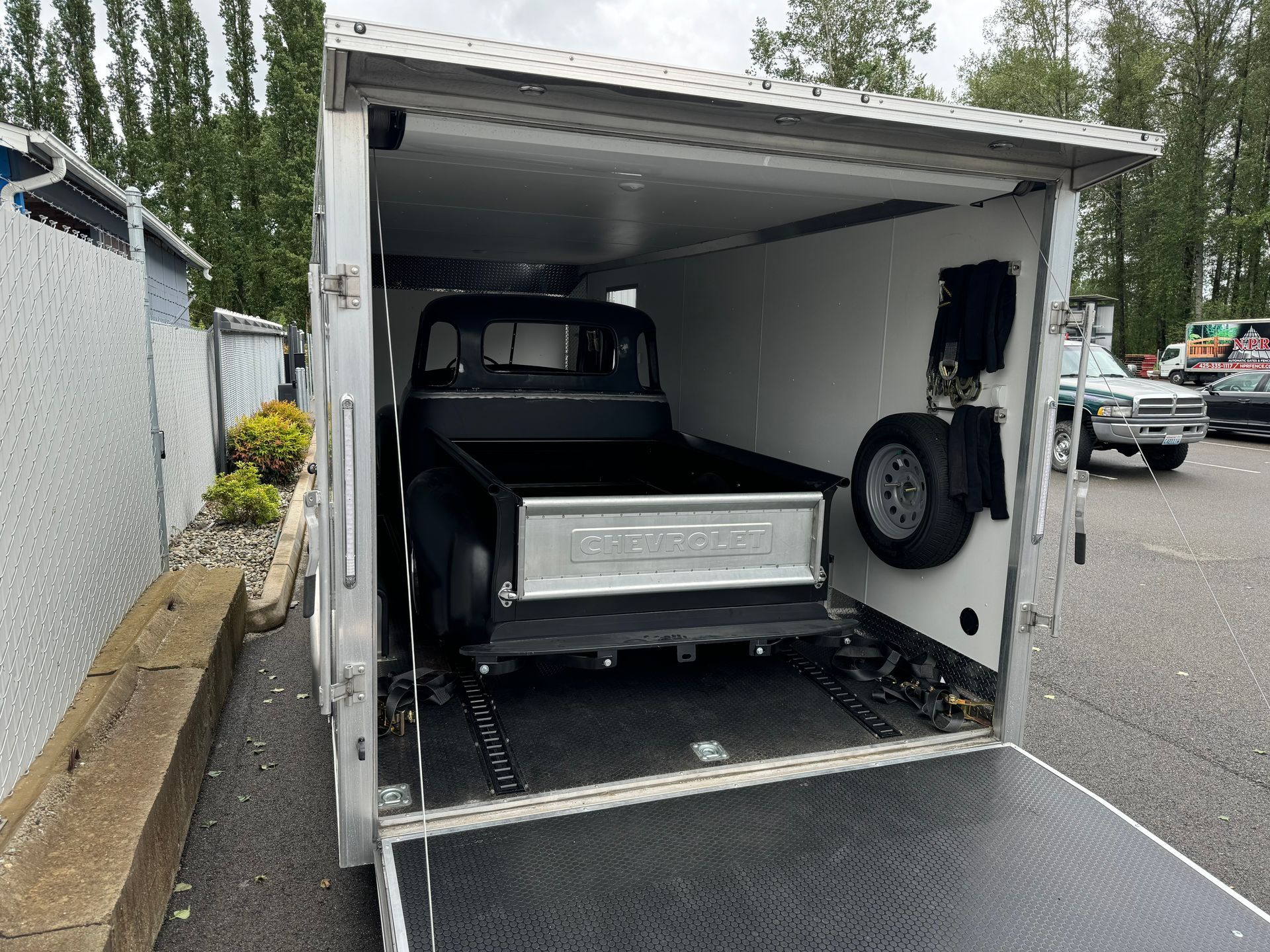 A truck is sitting inside of a trailer.