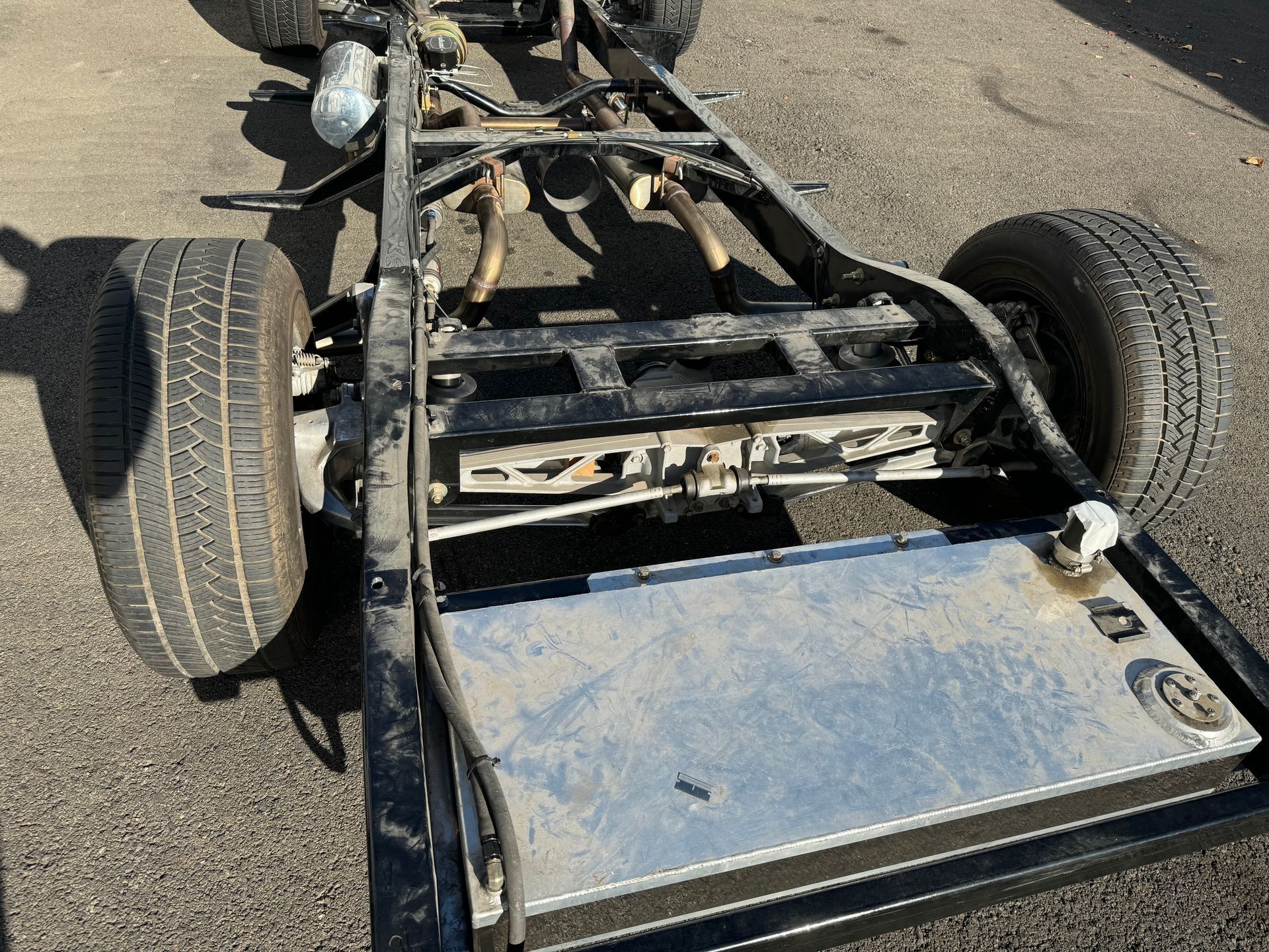 The chassis of a truck is sitting on the ground.