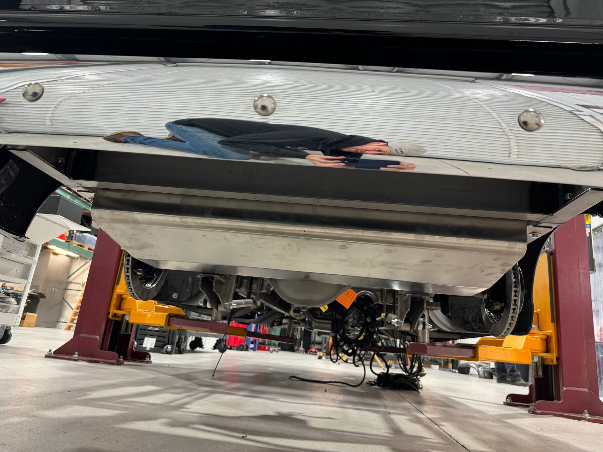 A car is sitting on a lift in a garage.