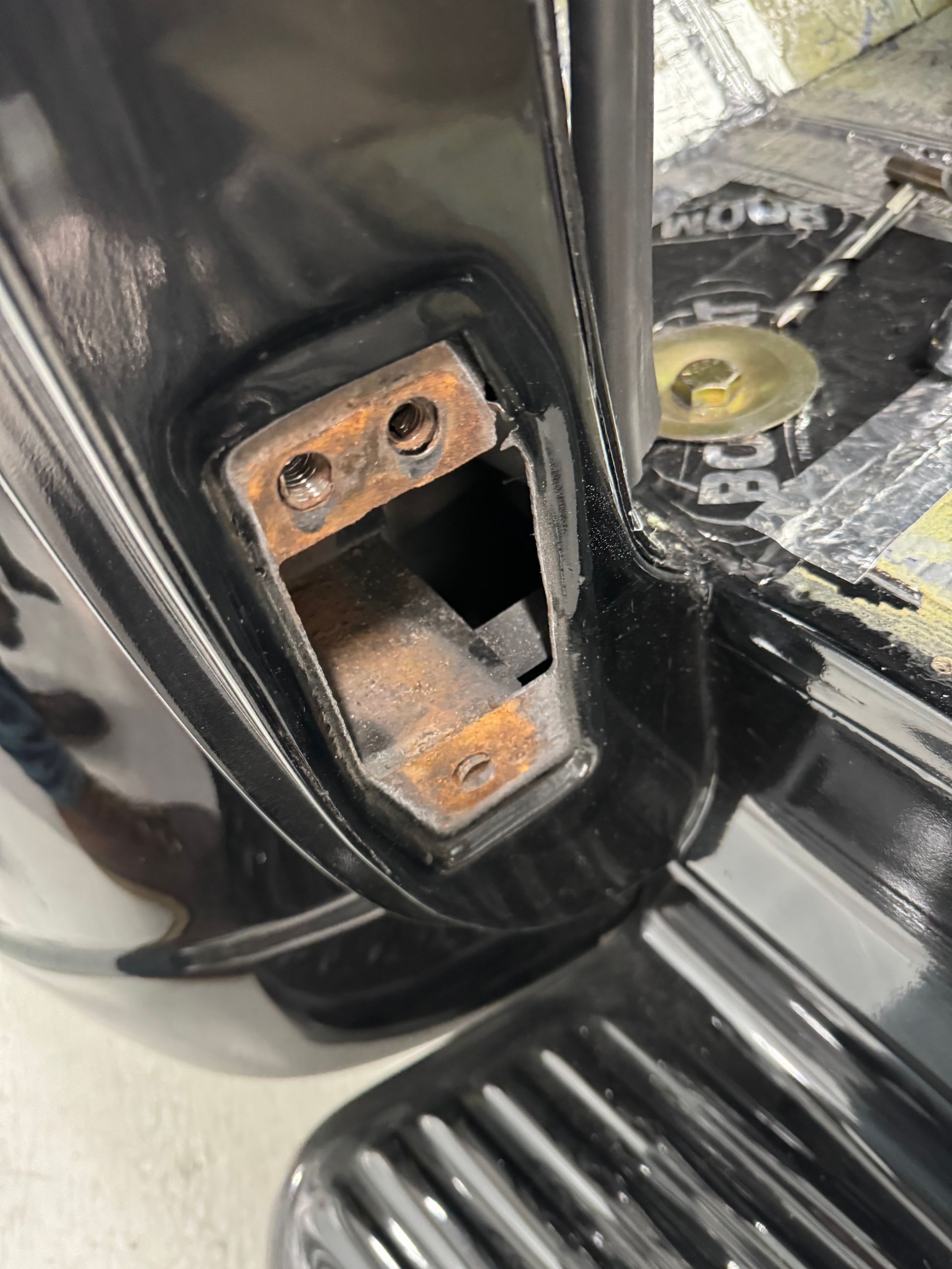 A close up of a door lock on a black car.