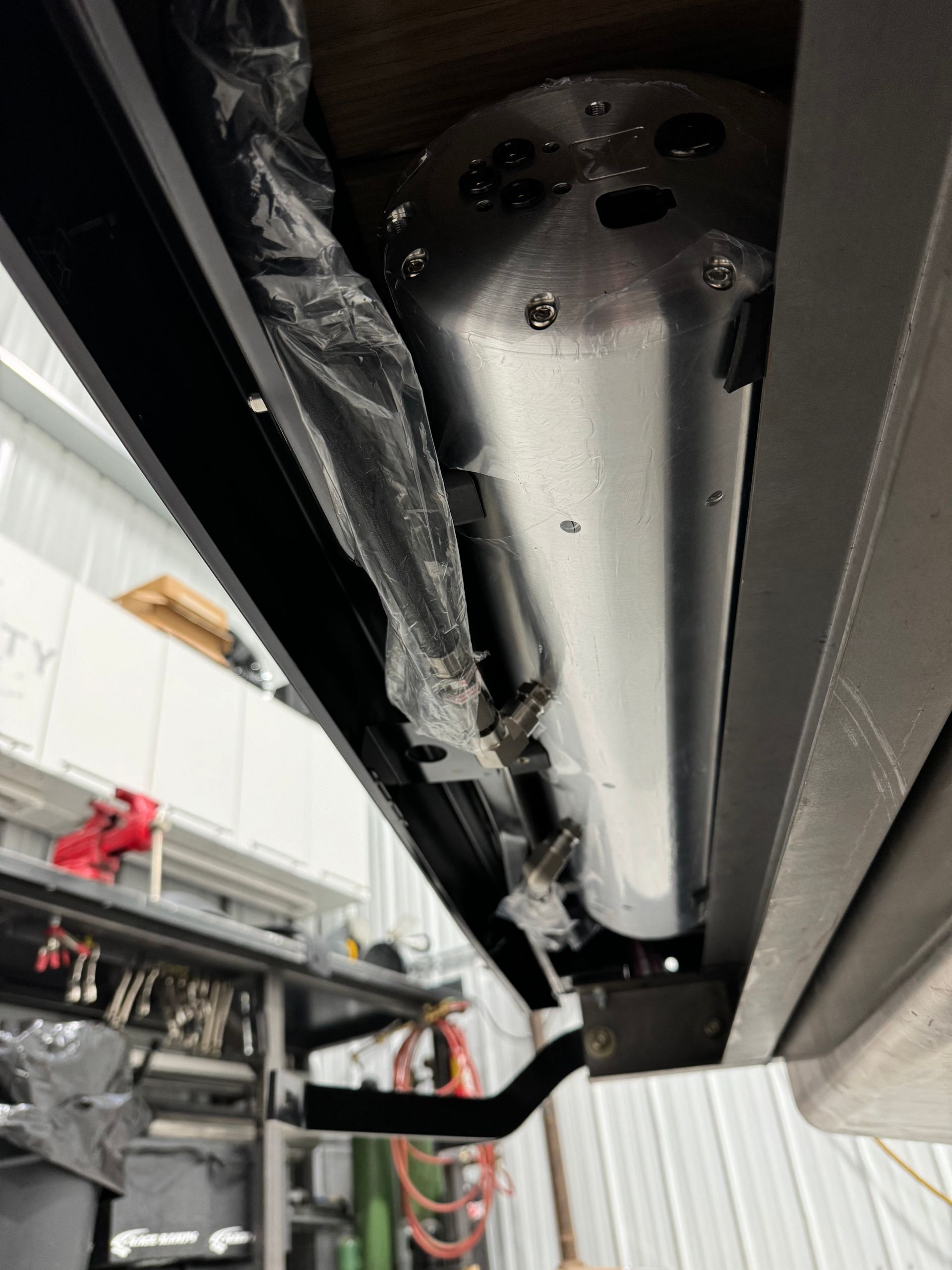 A close up of a metal pipe in a garage