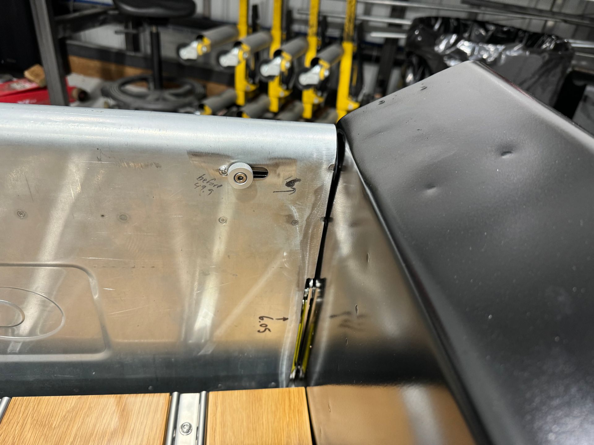 A piece of metal is sitting on top of a wooden table.