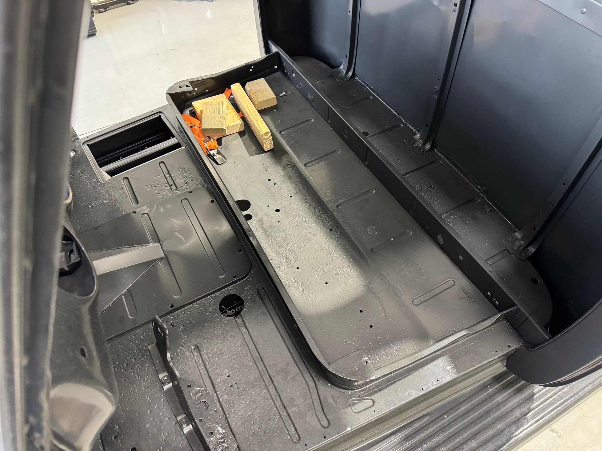 The inside of a car with a tray on the floor.