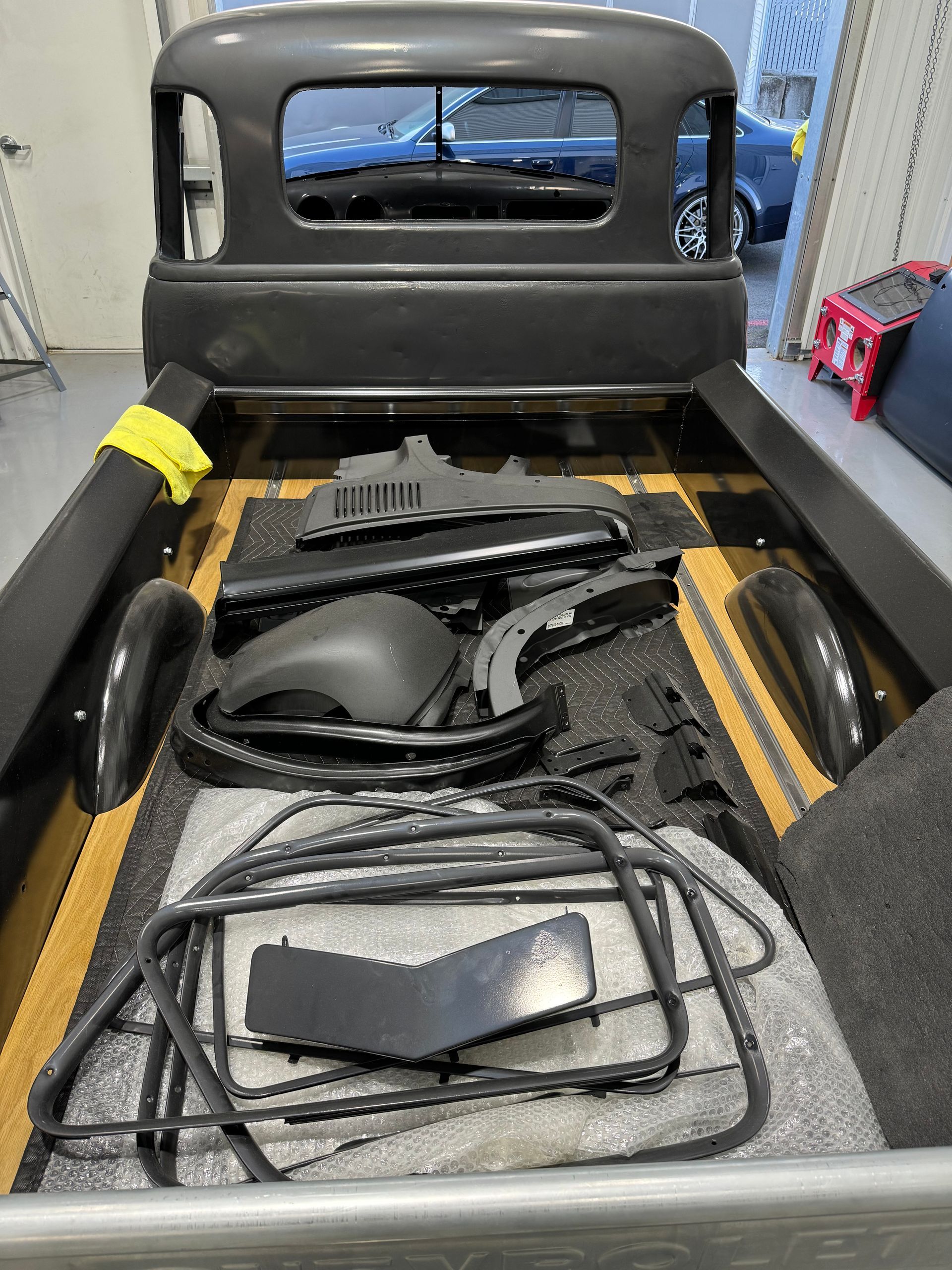 The back of a truck with a lot of parts in it