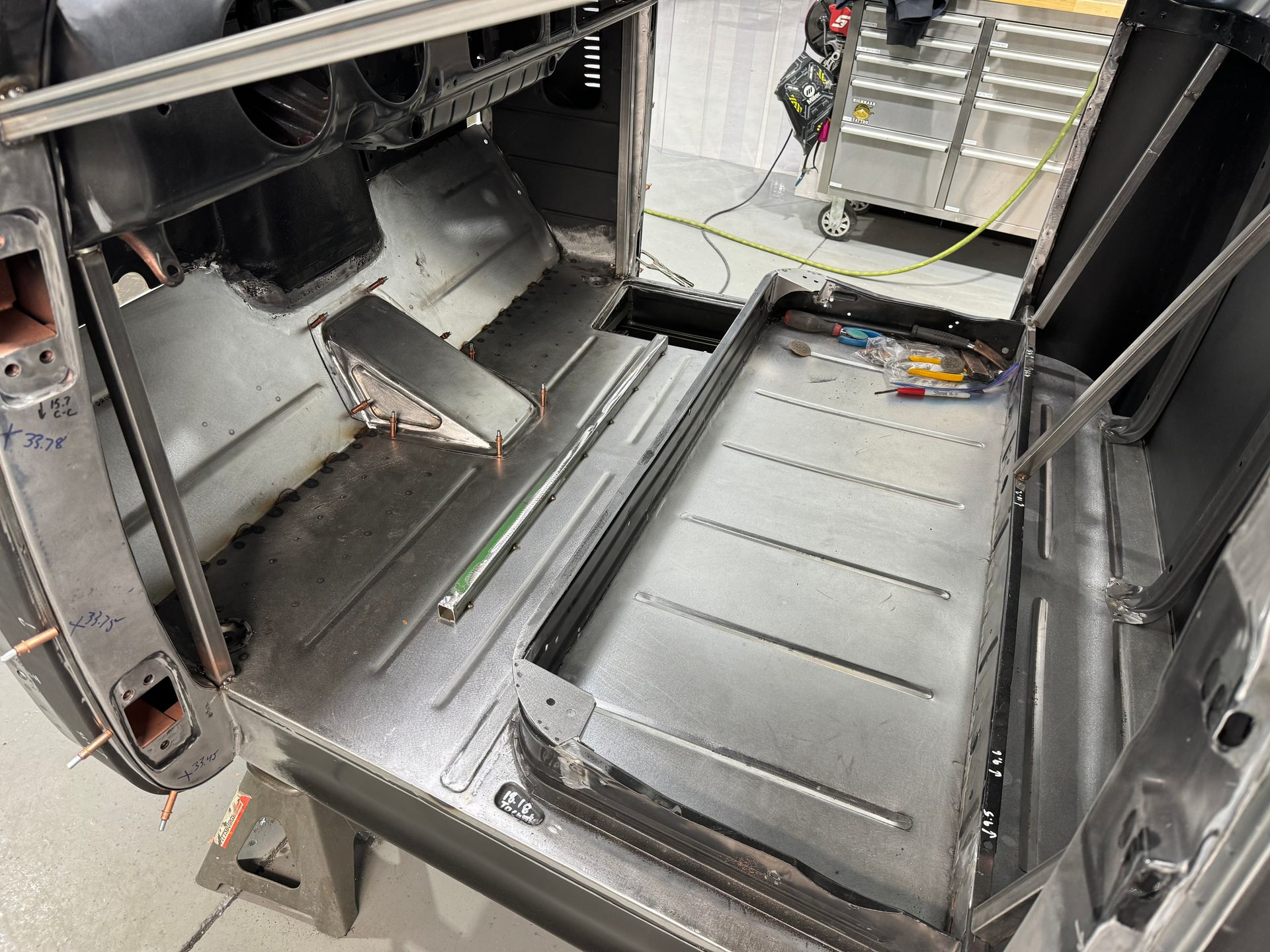 The inside of a car that is being built is shown.