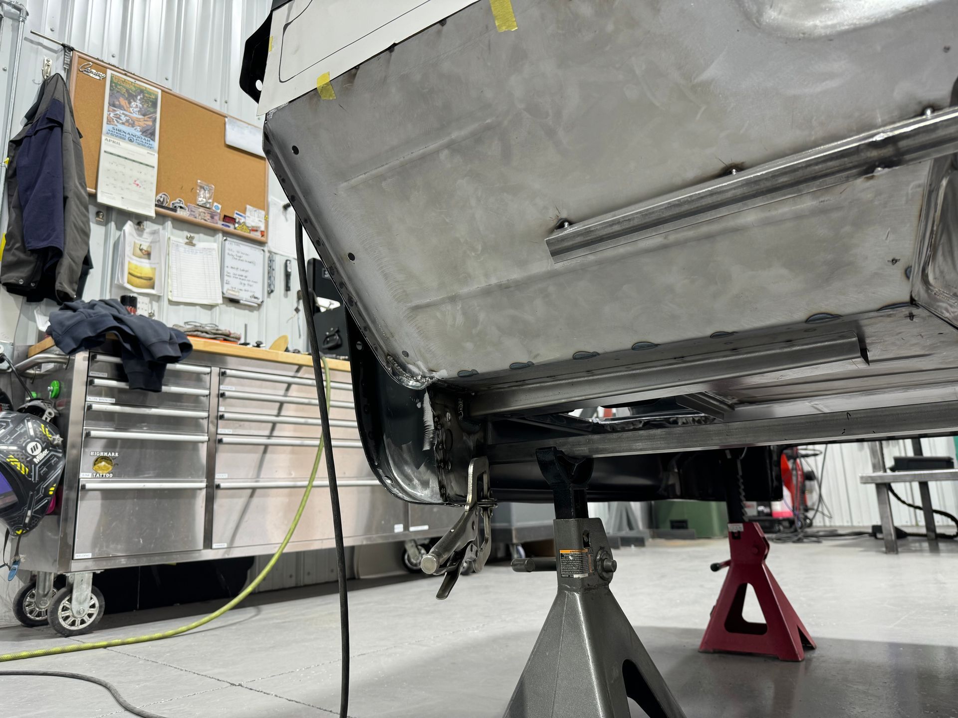 A car is being worked on in a garage.