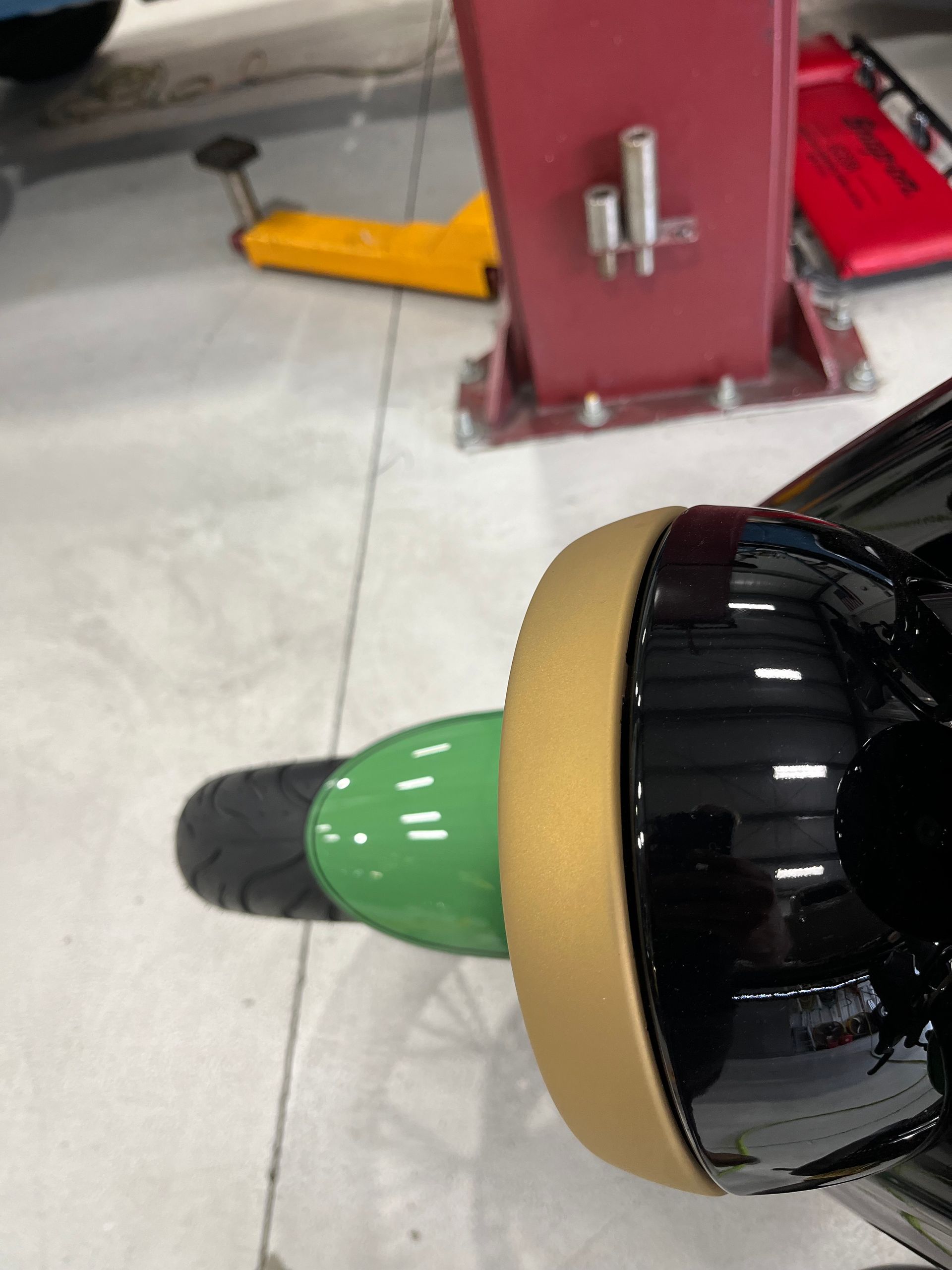 A close up of a person 's foot on a green scooter