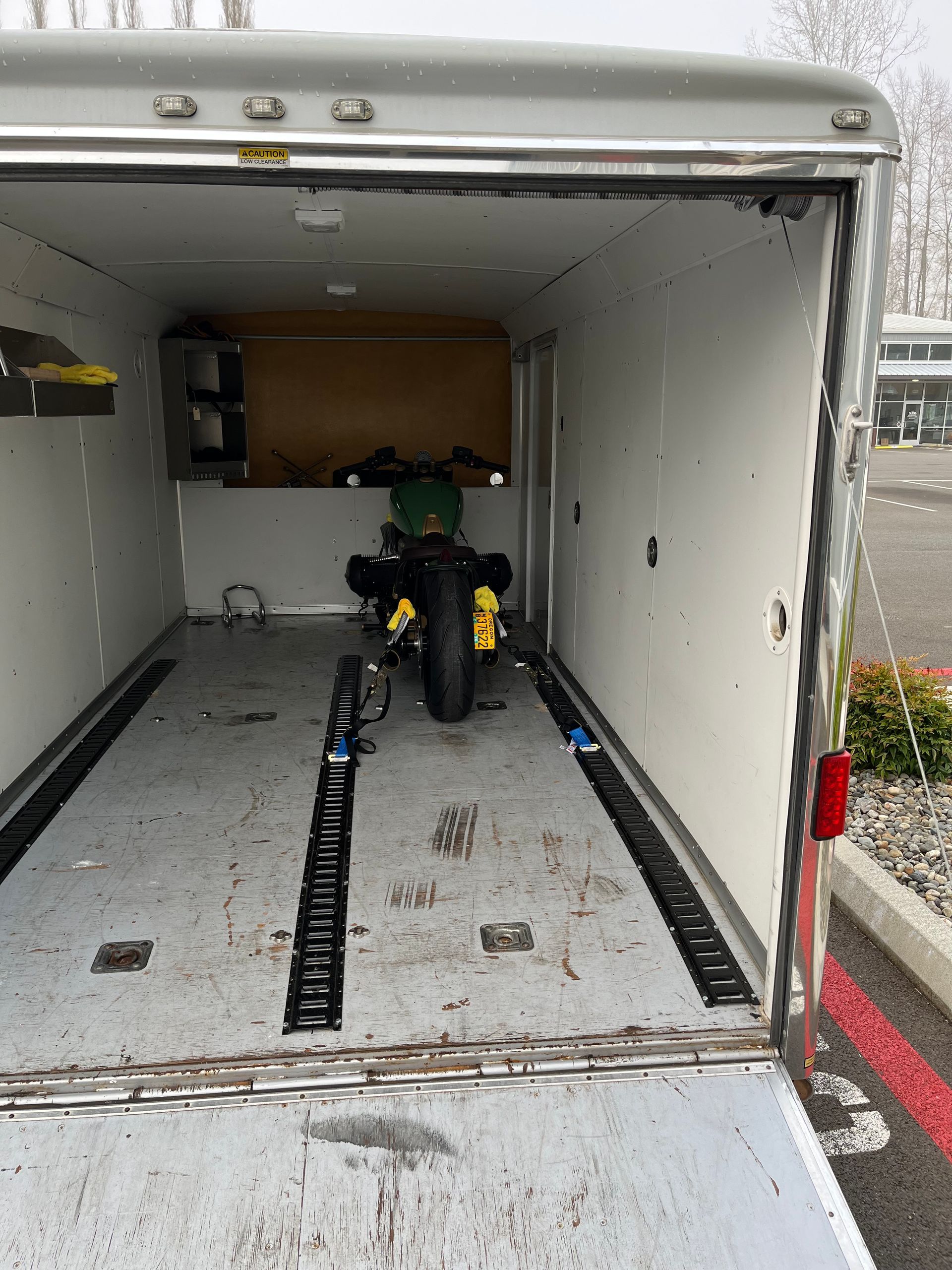A motorcycle is parked inside of a trailer.