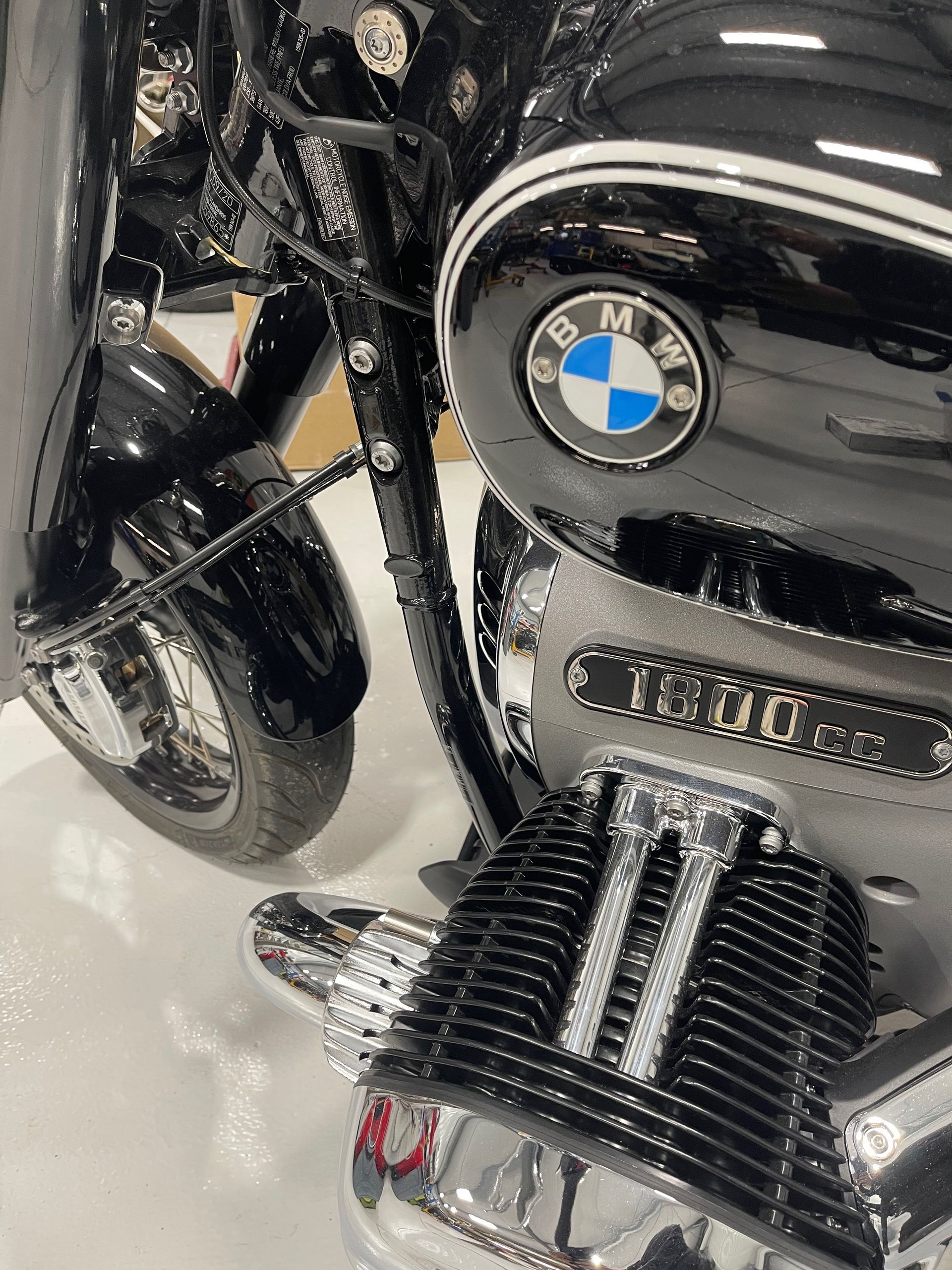 A black bmw motorcycle is parked in a garage.