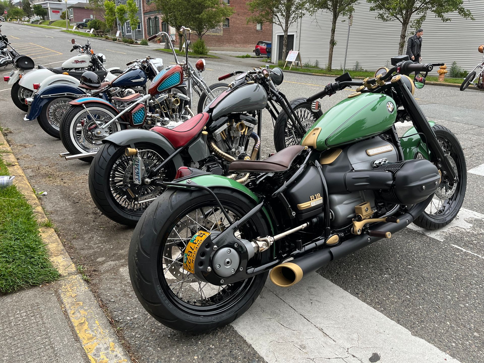 A row of motorcycles are parked on the side of the road.
