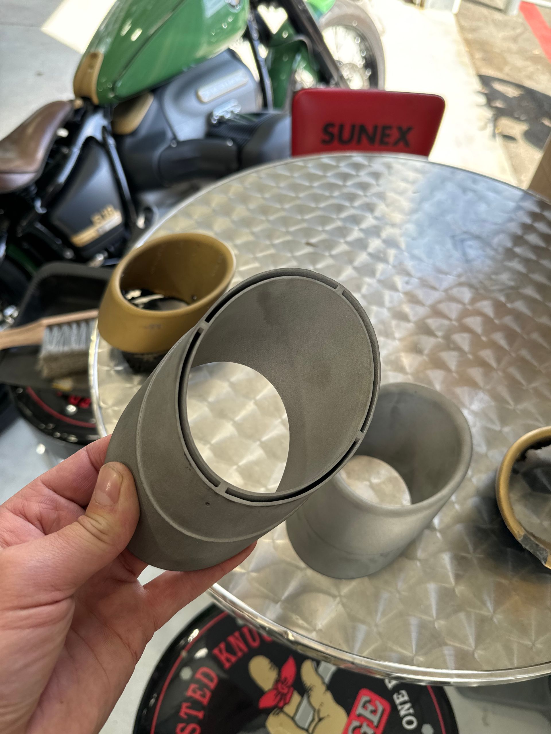 A person is holding a piece of metal in their hand