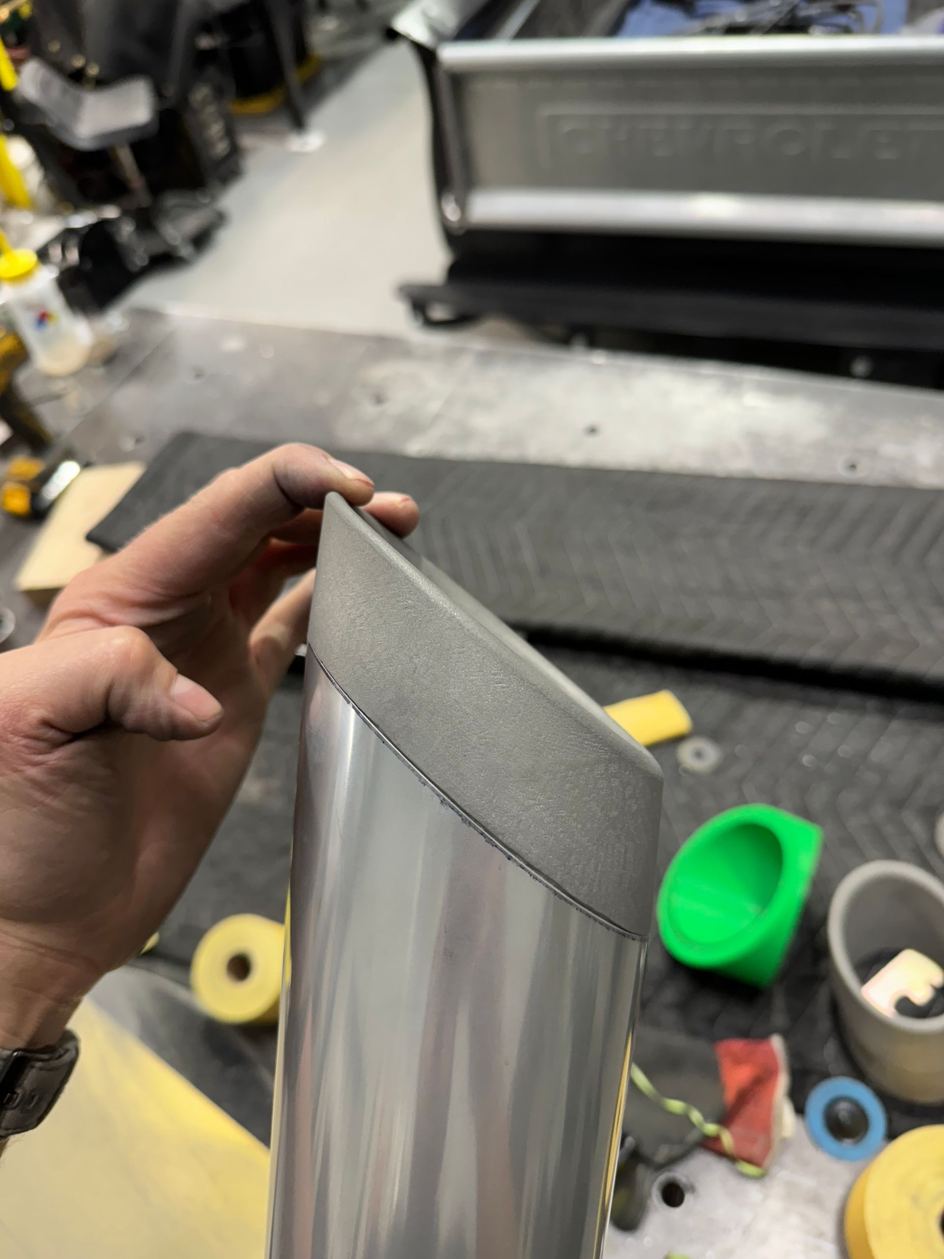 A person is holding a piece of metal in their hand.