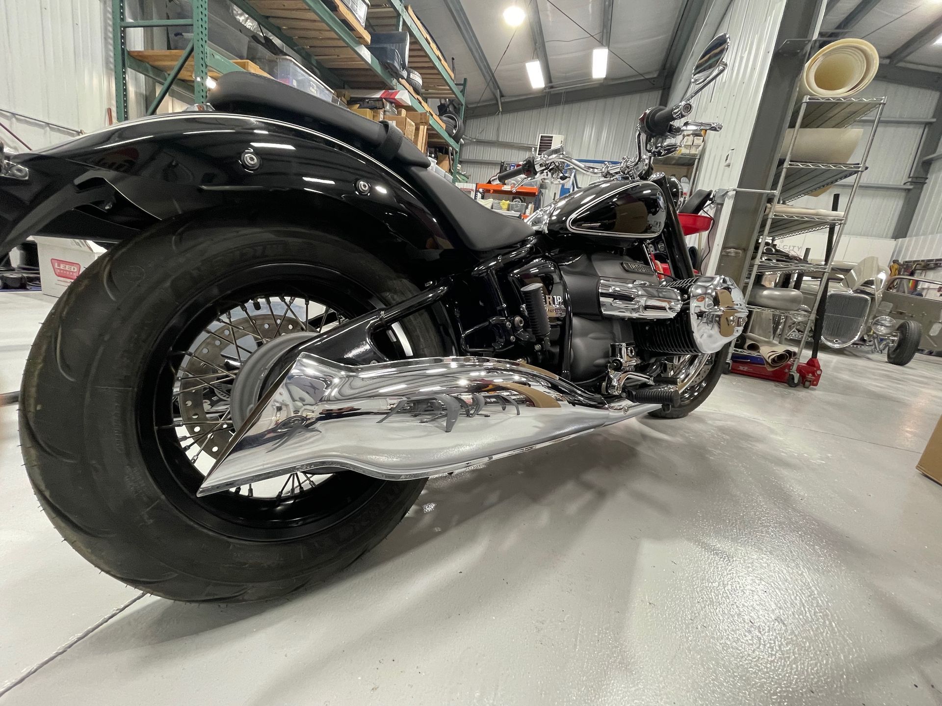A black motorcycle is parked in a garage.