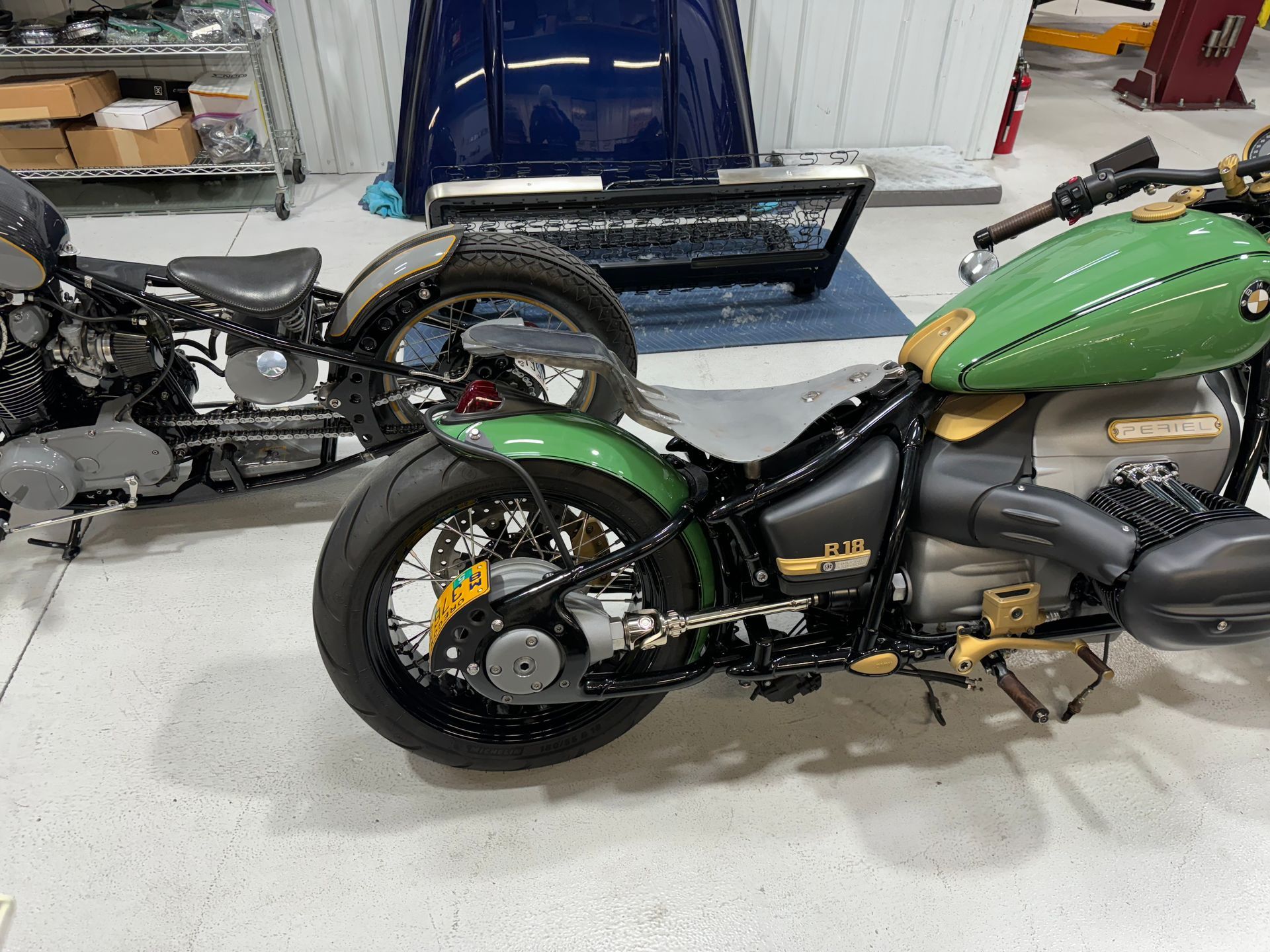 Two motorcycles are parked next to each other in a garage.