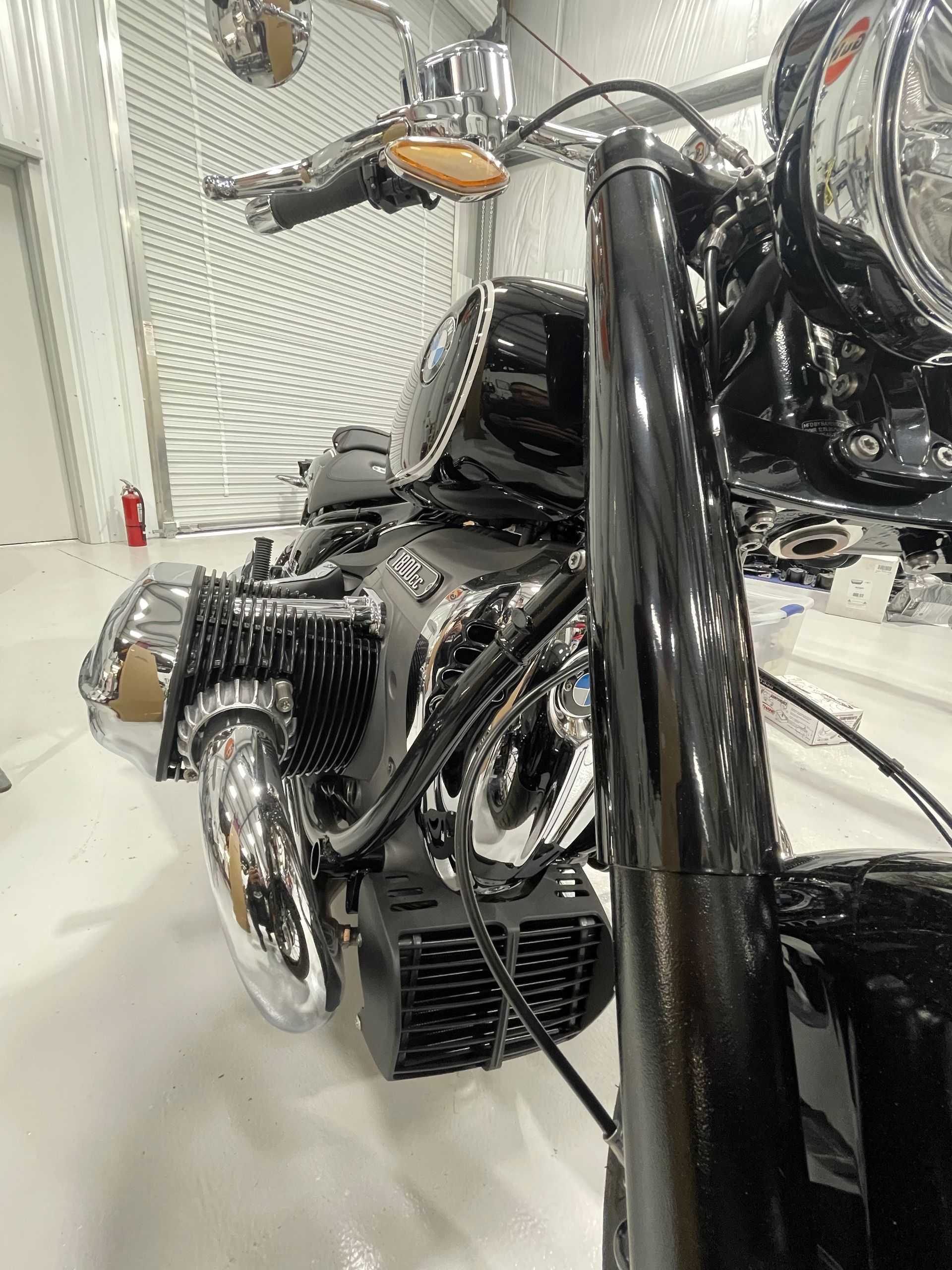 A black motorcycle is parked in a garage.