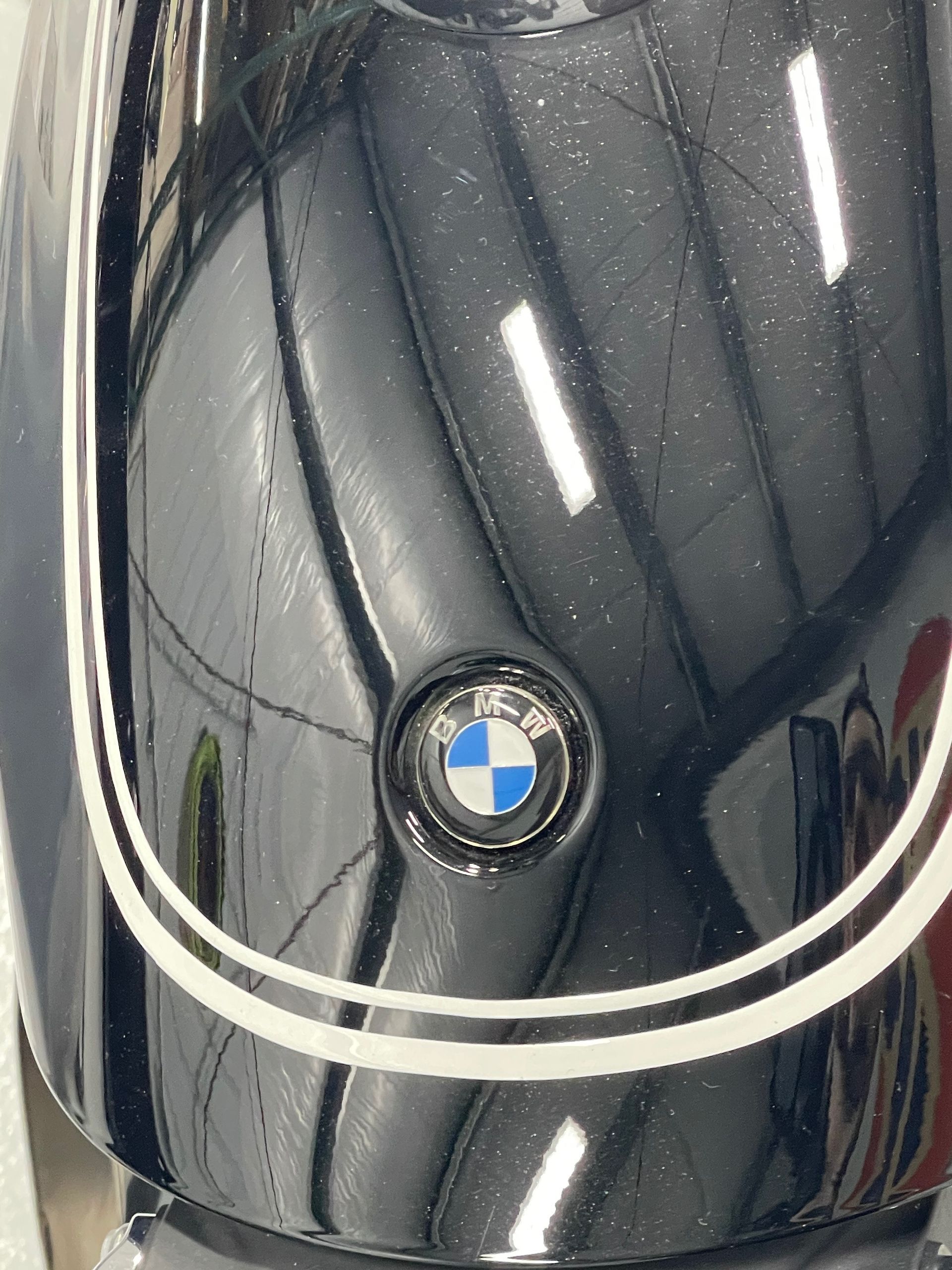 A close up of a bmw logo on the front of a black car.