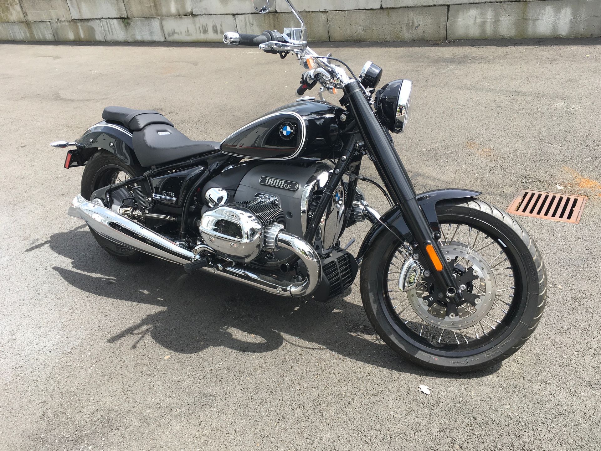 A black motorcycle is parked on the side of the road.