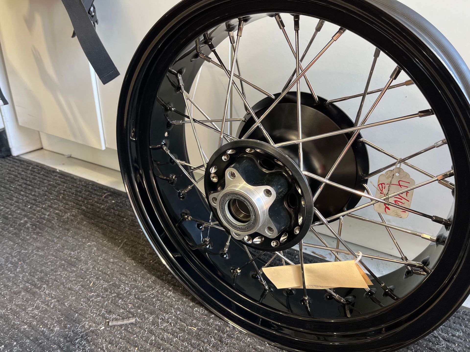 A close up of a motorcycle wheel on the ground