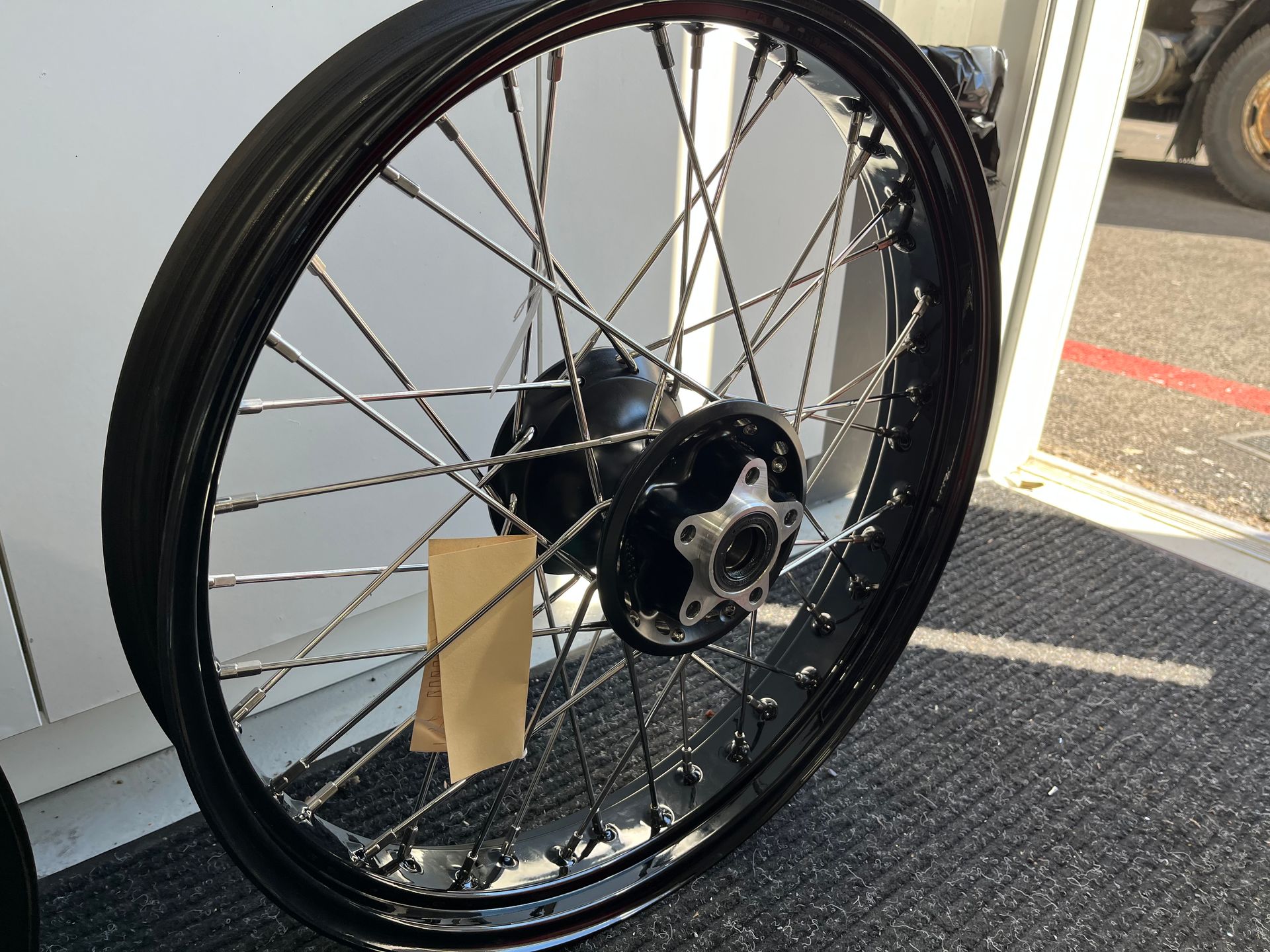 A close up of a bicycle wheel with a tag on it