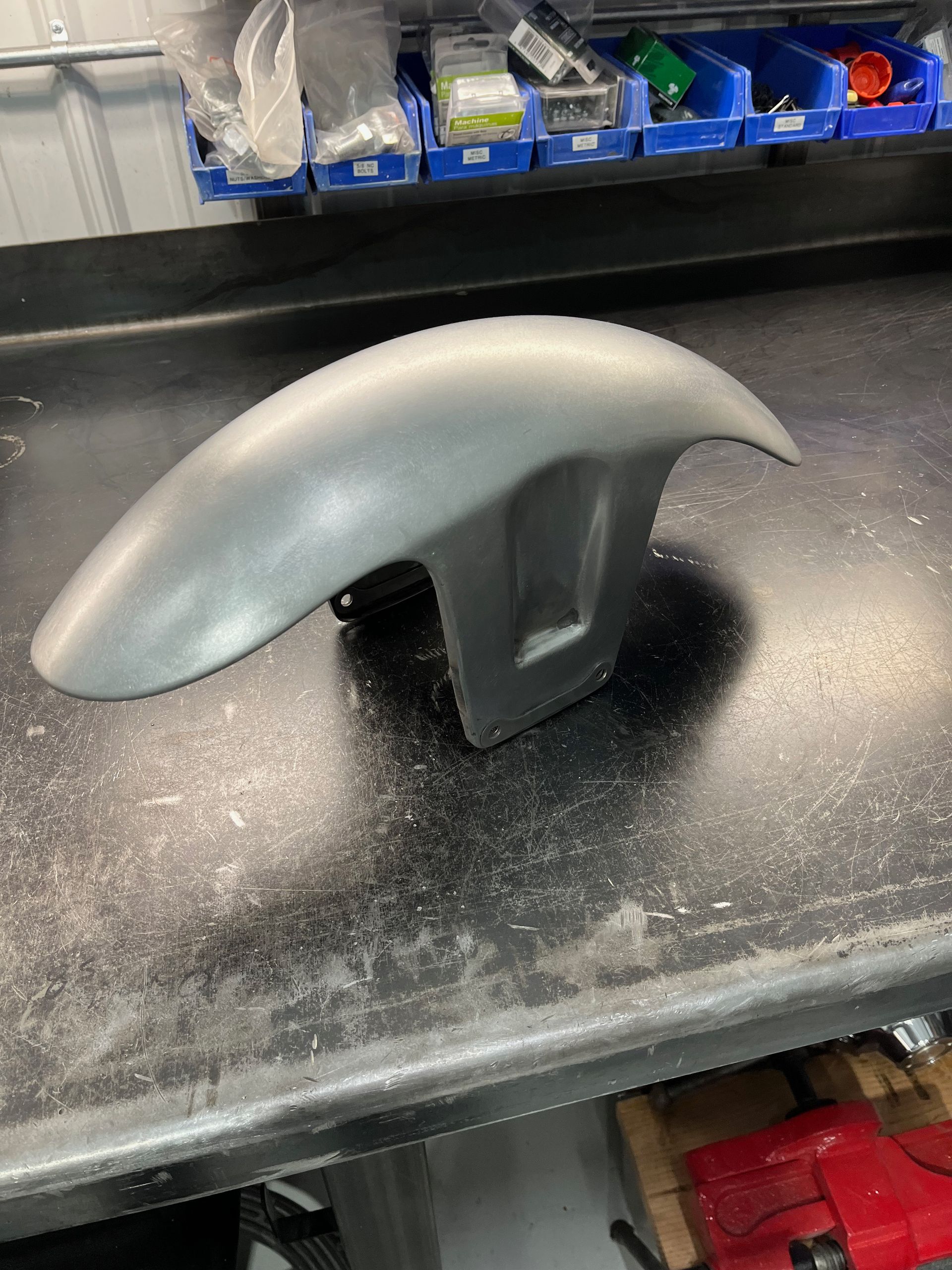 A fender is sitting on top of a black counter.