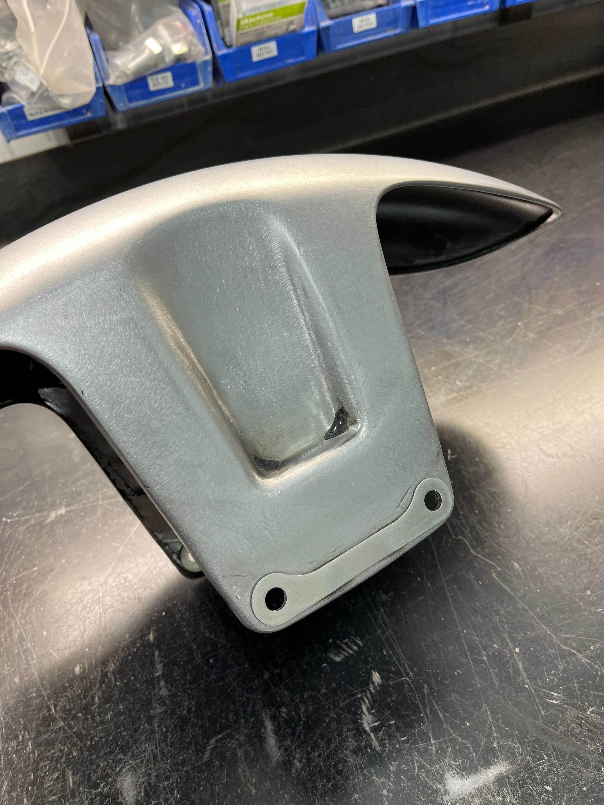 A close up of a front fender on a table.