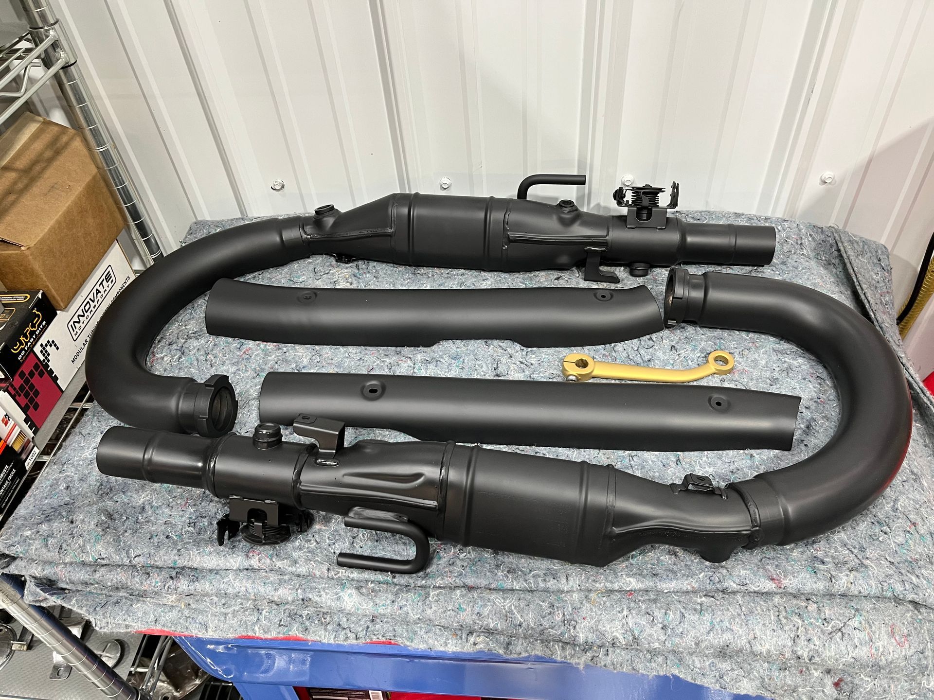 A bunch of black pipes are sitting on top of a table.